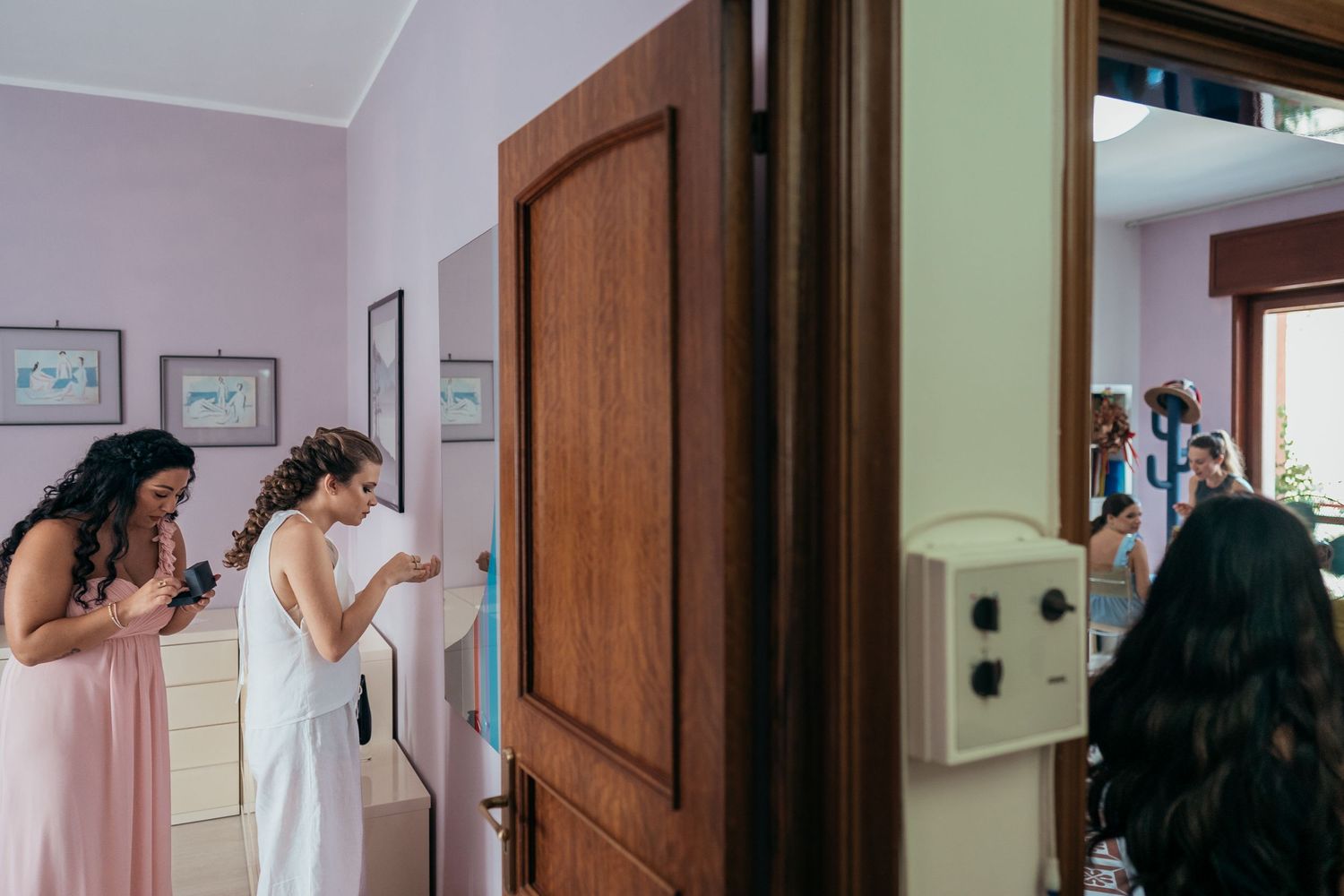 People peering through a doorway in anticipation.