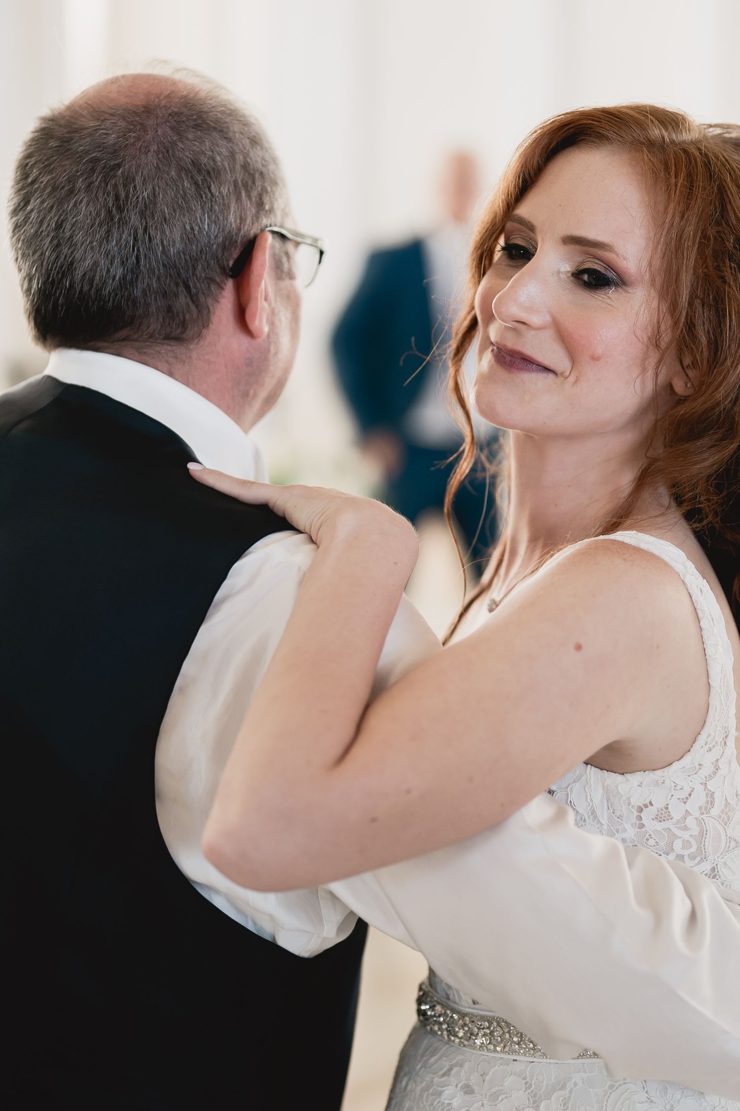 An intimate moment during a wedding dance in an elegant reception setting.