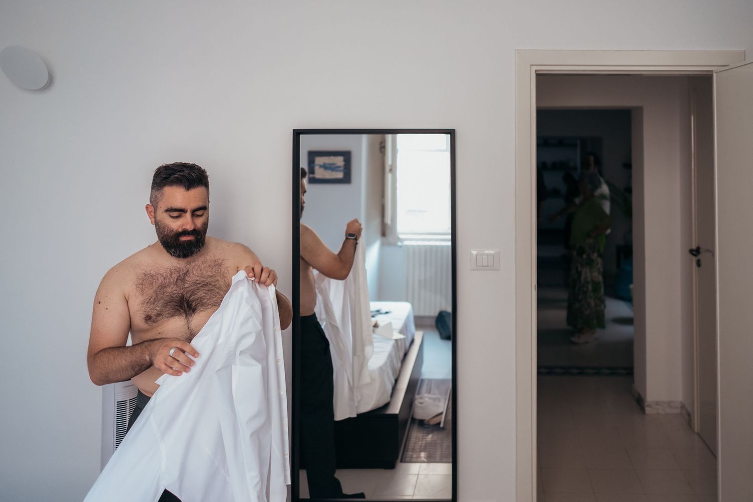 Person getting ready while looking in mirror.