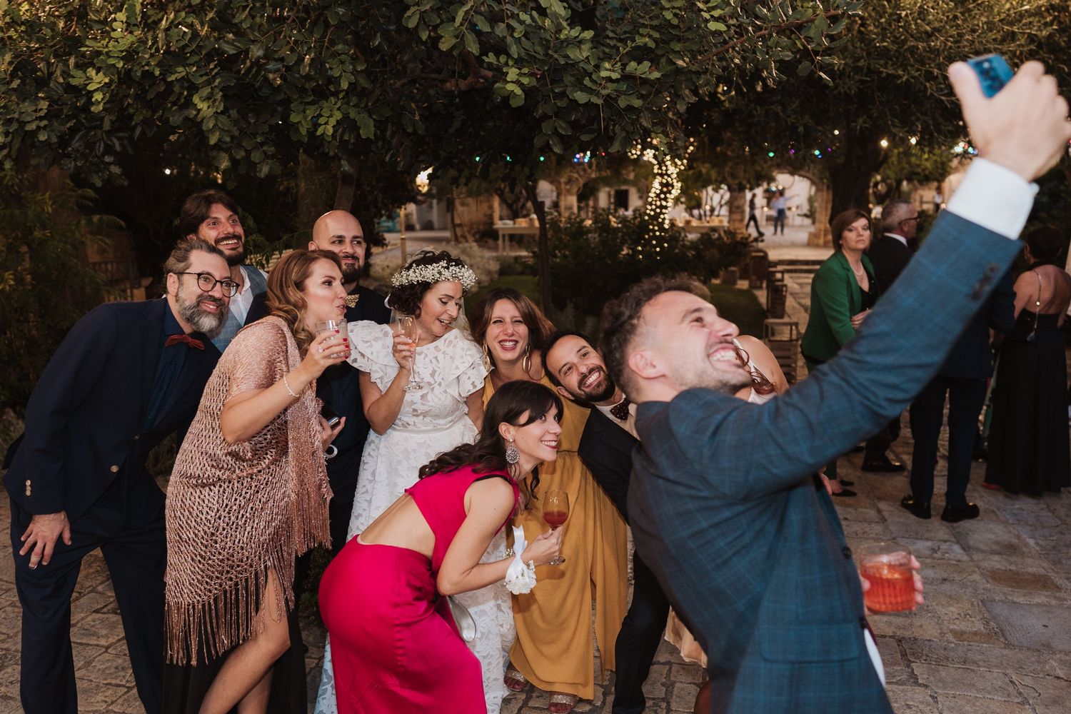 Wedding guests pose together for a fun group selfie during the celebration.