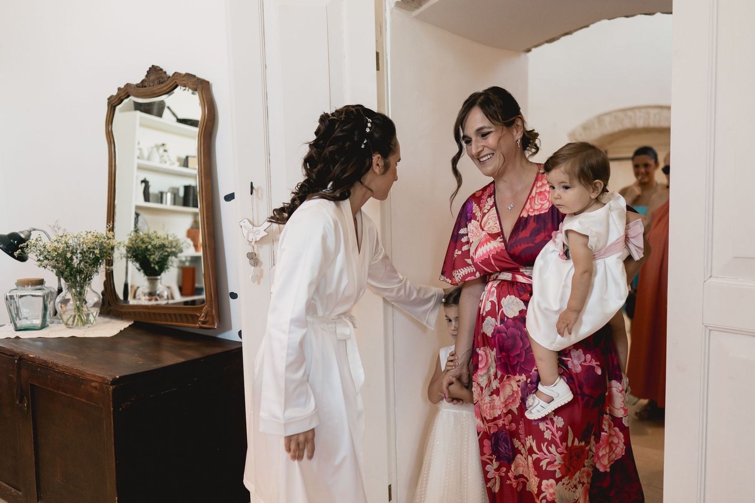 Wedding preparation scene in a room with a mirror and elegant decor.