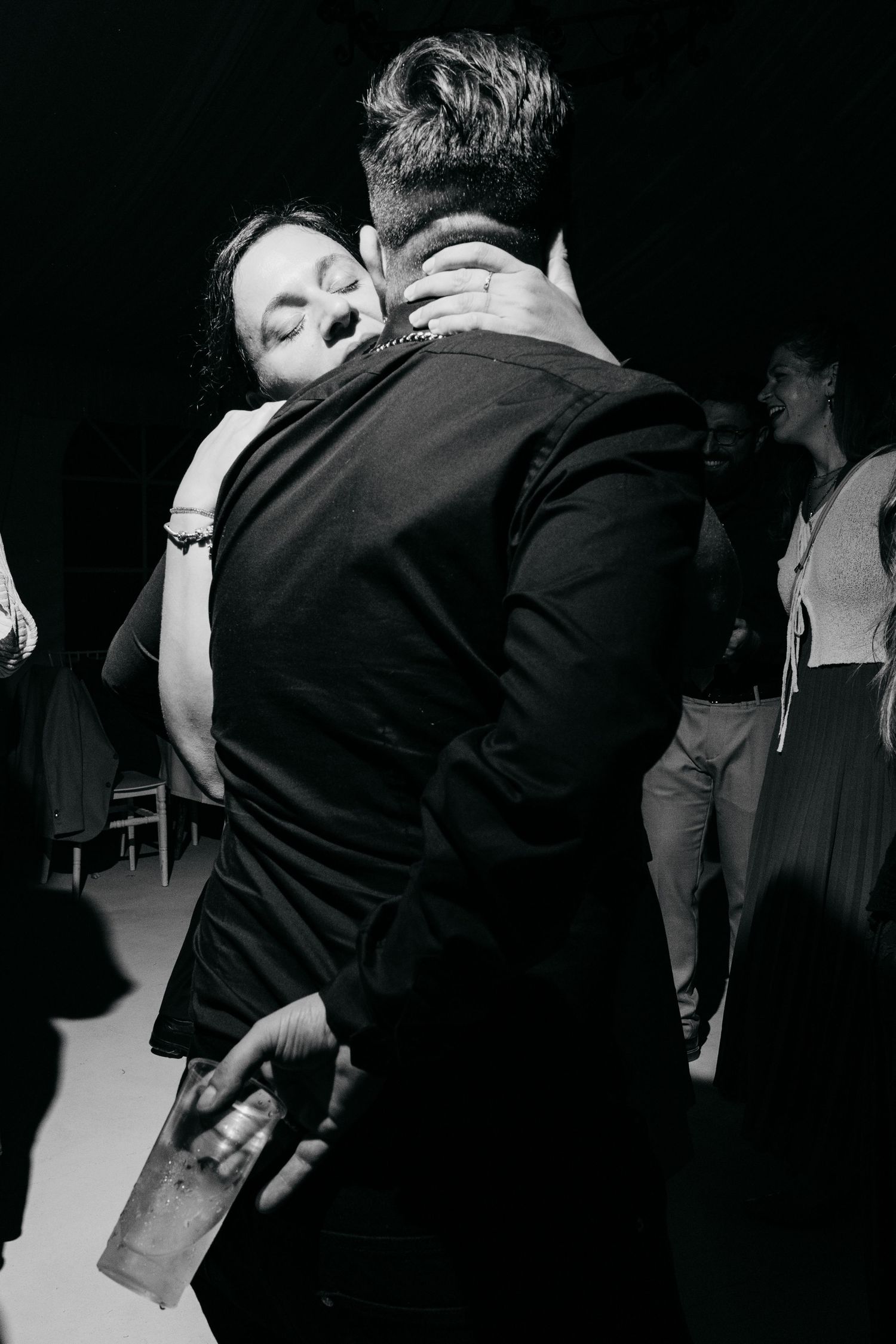 Black and white images show intimate dancing moments at a wedding celebration.