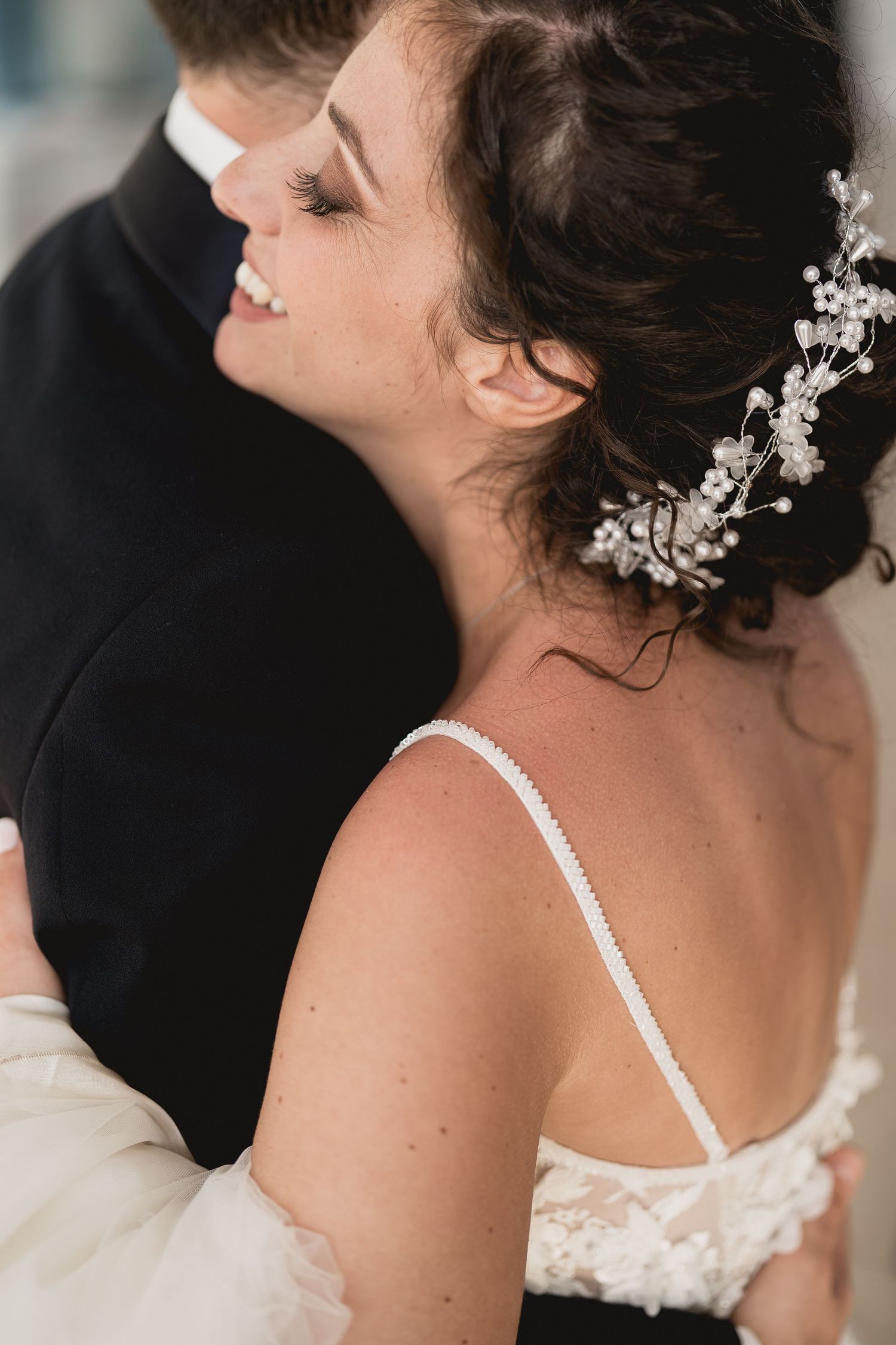 Close-up of bridal hair accessory with delicate floral details and beading.