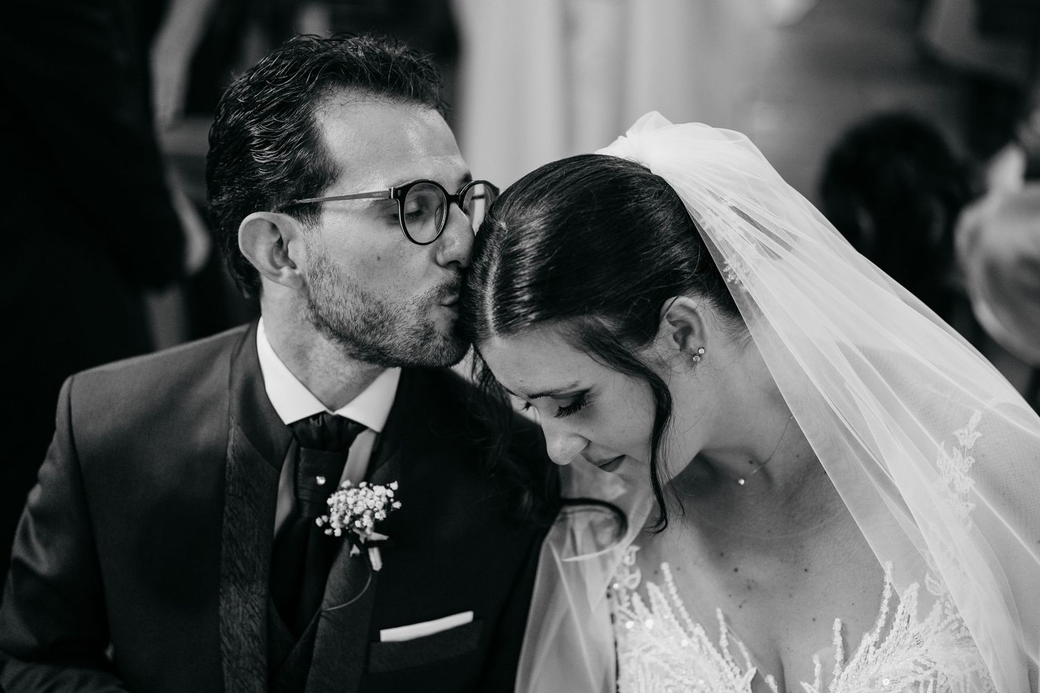 A tender black and white moment captured during an intimate wedding ceremony.