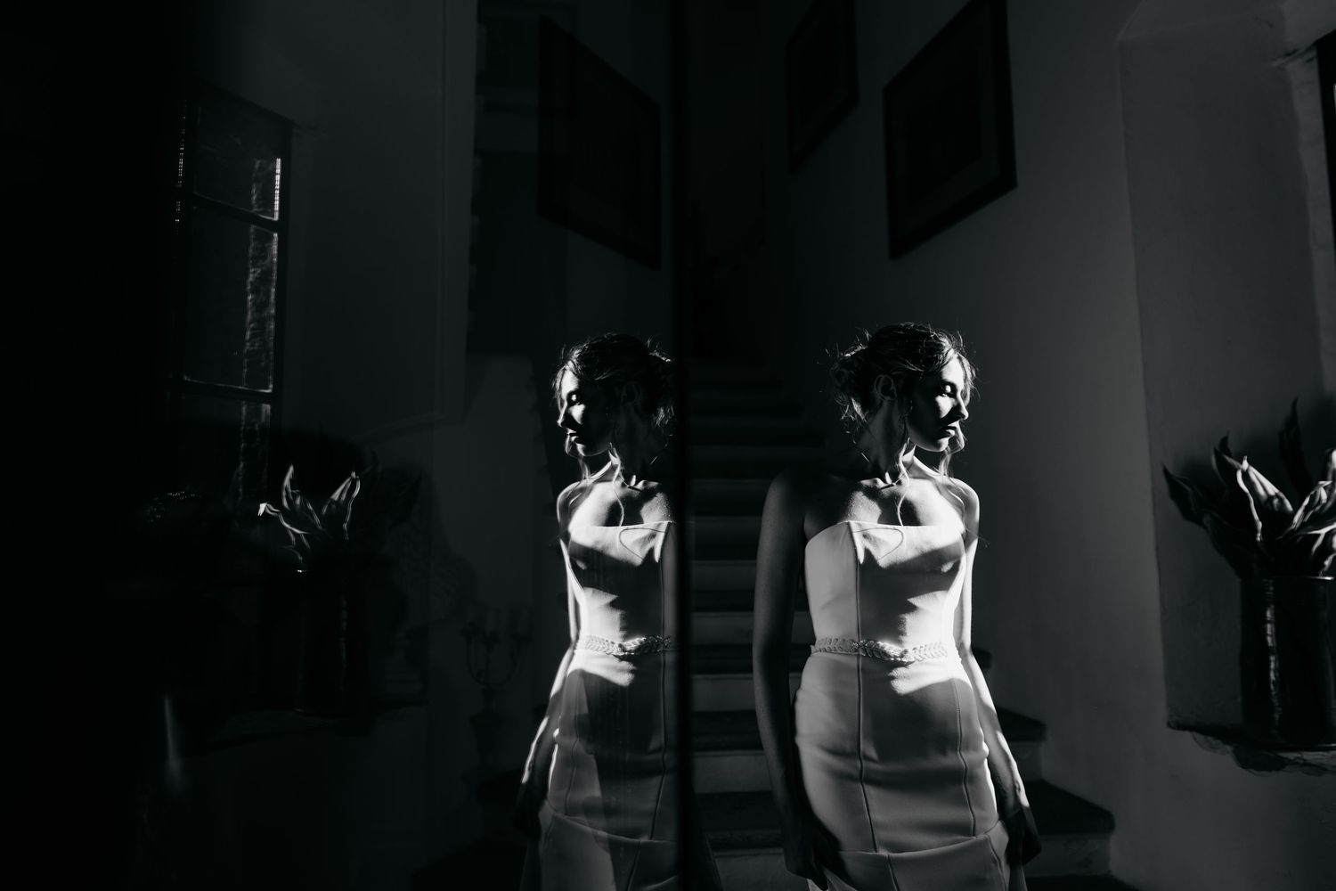 Dramatic black and white silhouettes in an atmospheric indoor setting.