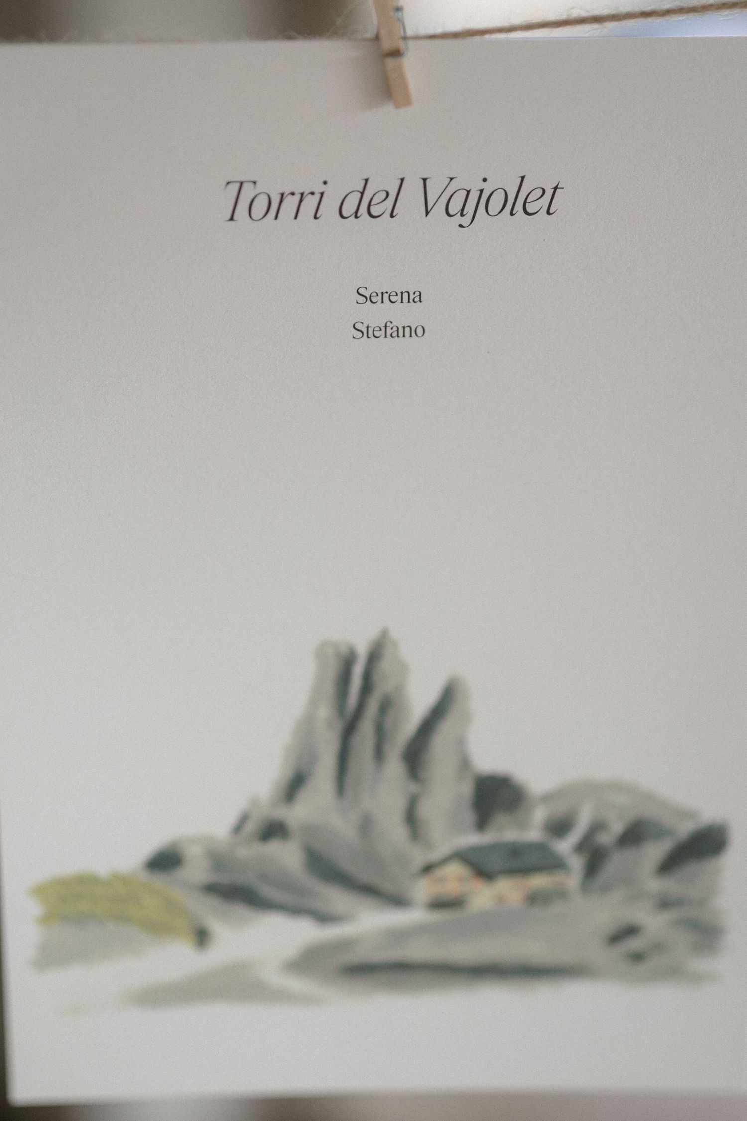 Minimalist watercolor painting series showing the Torri del Vajolet mountain peaks in soft gray tones against white background.