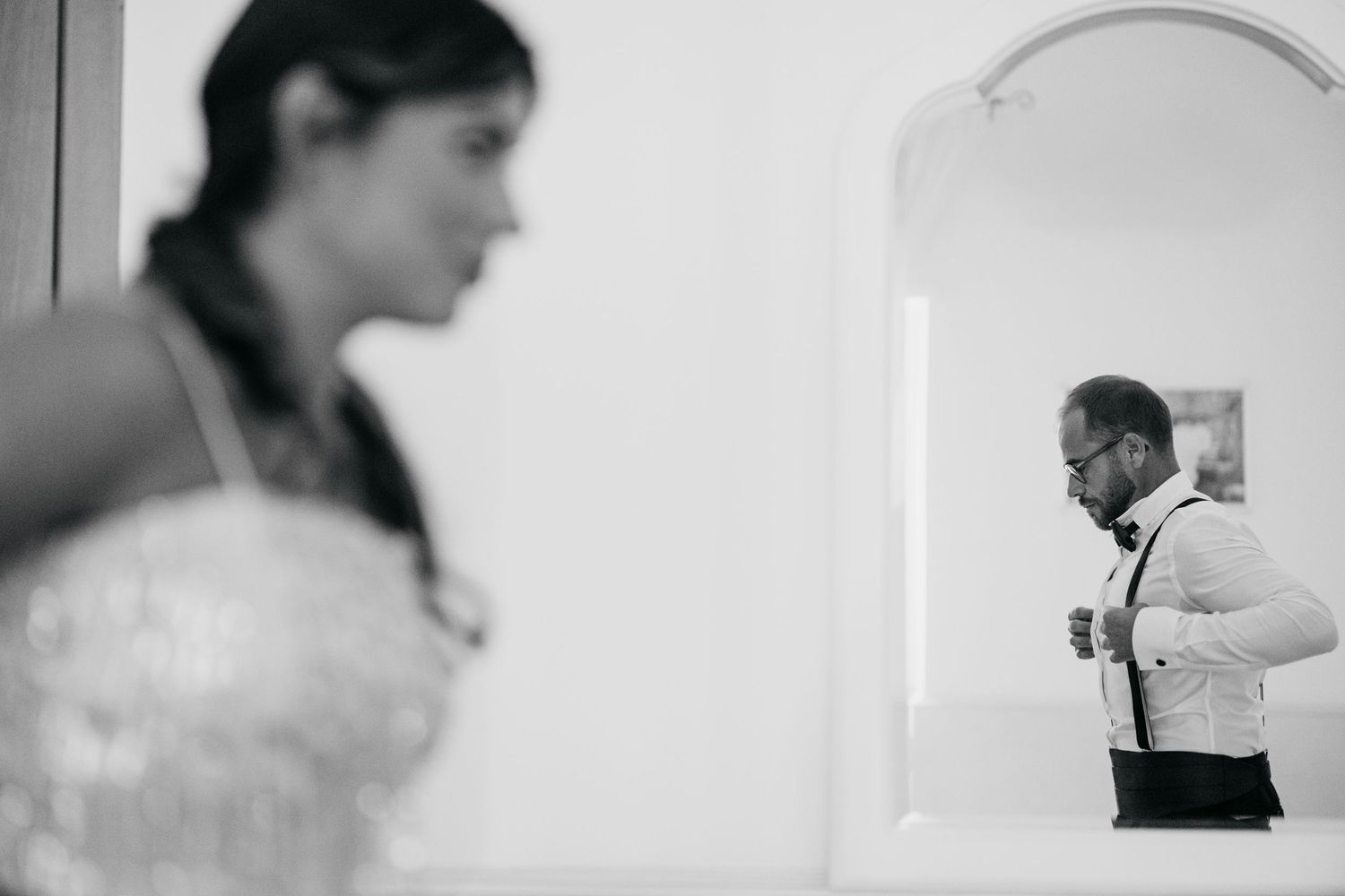 Black and white artistic wedding photography sequence showing intimate moments and preparations.