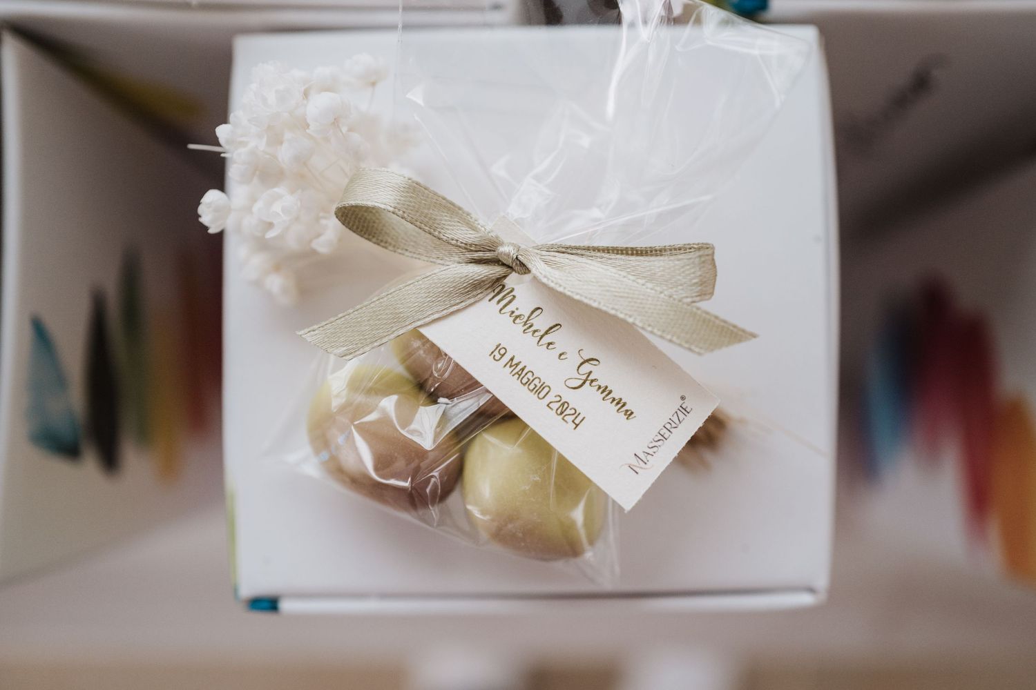Small wedding favor box with white ribbon and floral accents featuring a thank you tag.