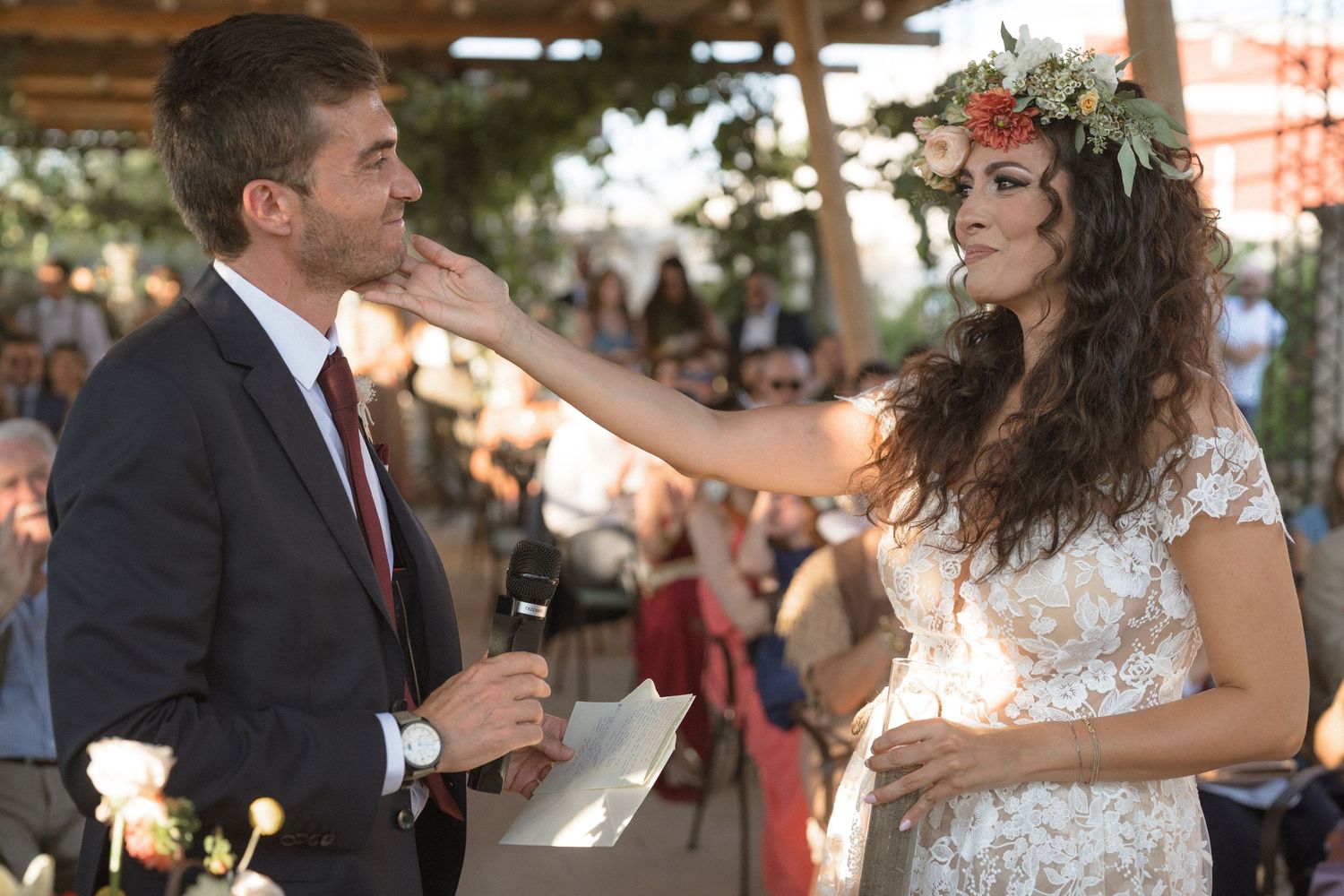 Guests mingle and celebrate at a rustic outdoor wedding reception.