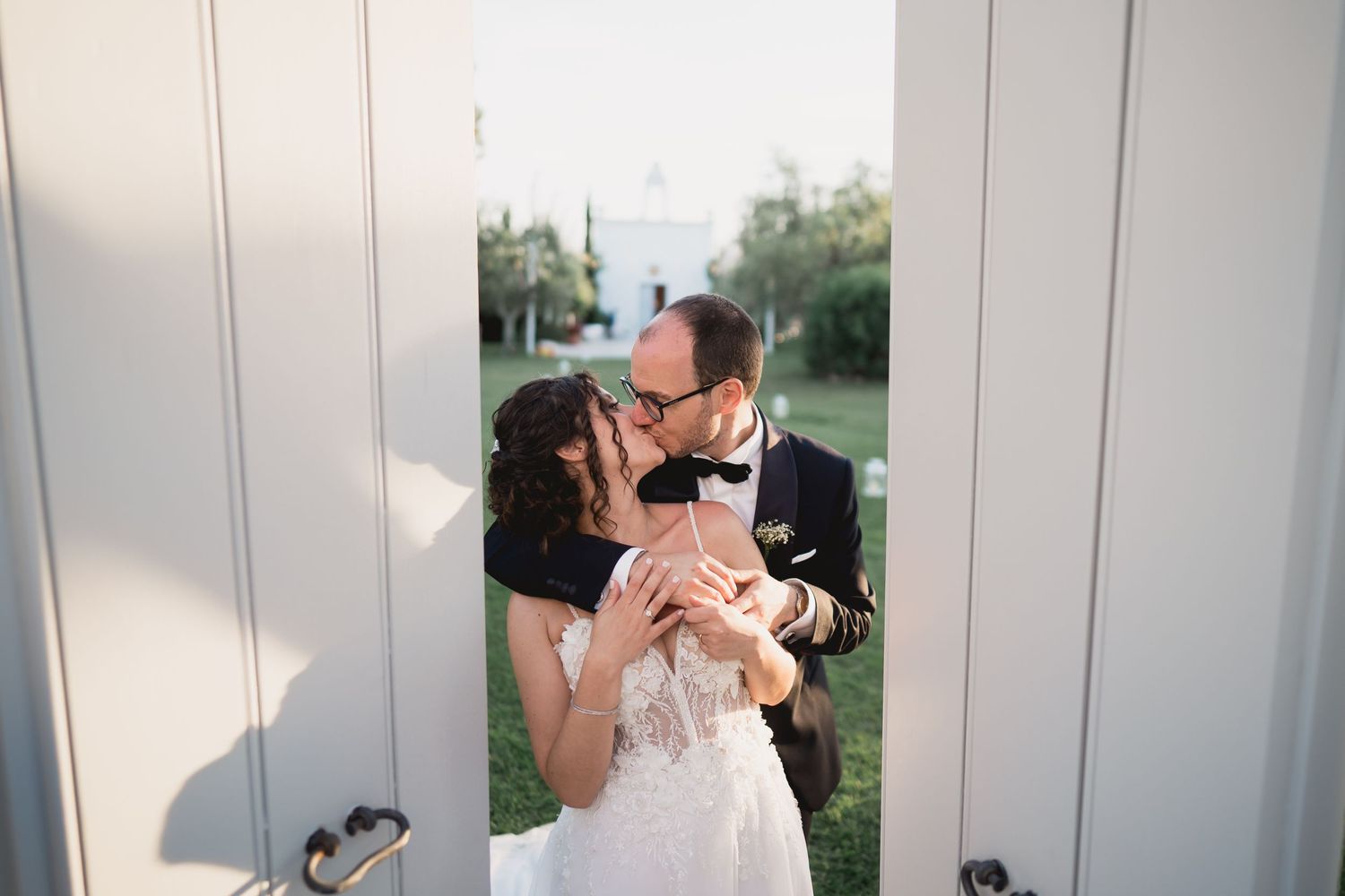 A tender moment between newlyweds captured in soft natural lighting.