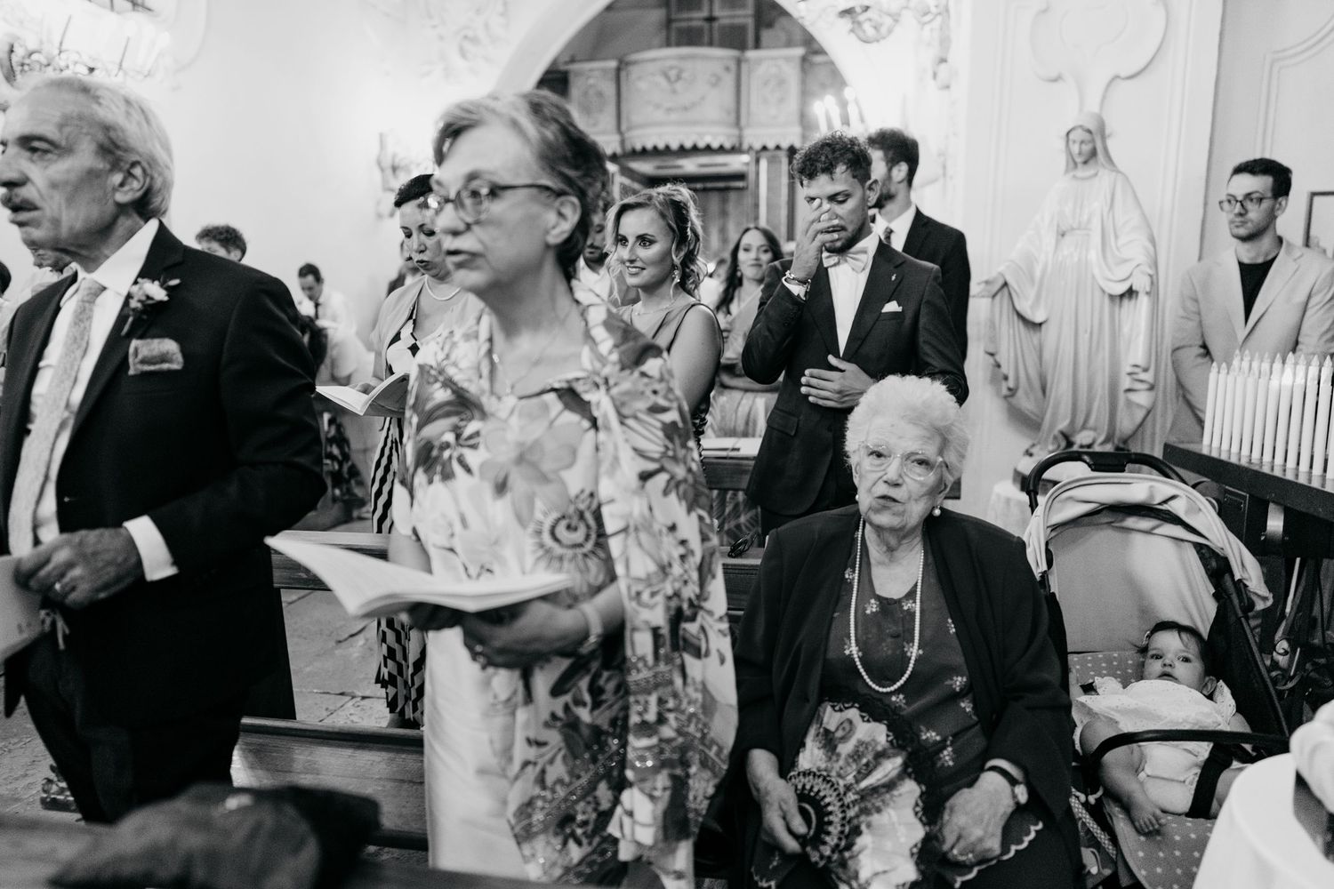 Wedding guests share joyful moments during reception celebration in elegant indoor venue.