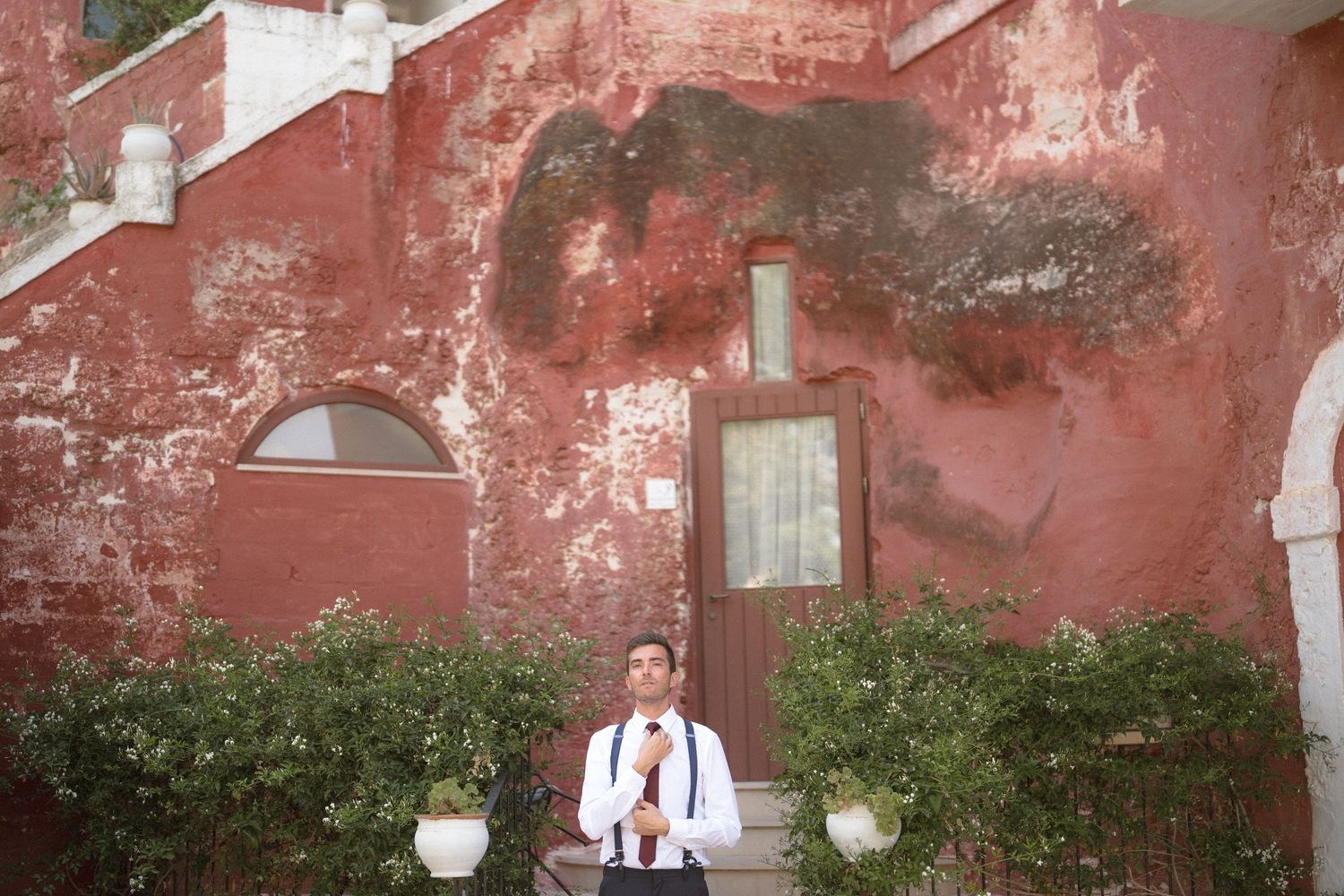 Wedding venue with weathered red walls and vintage architectural details.