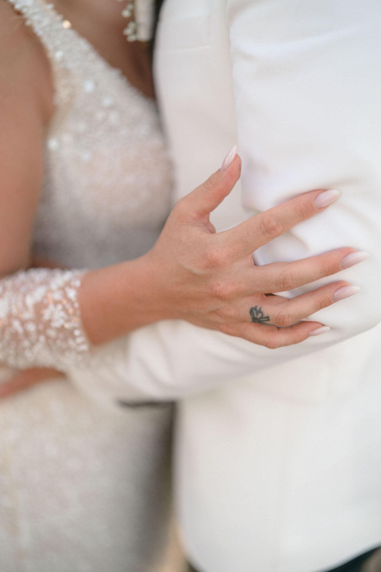 Close-up series of hands delicately holding and adjusting white fabric with a soft, ethereal quality.