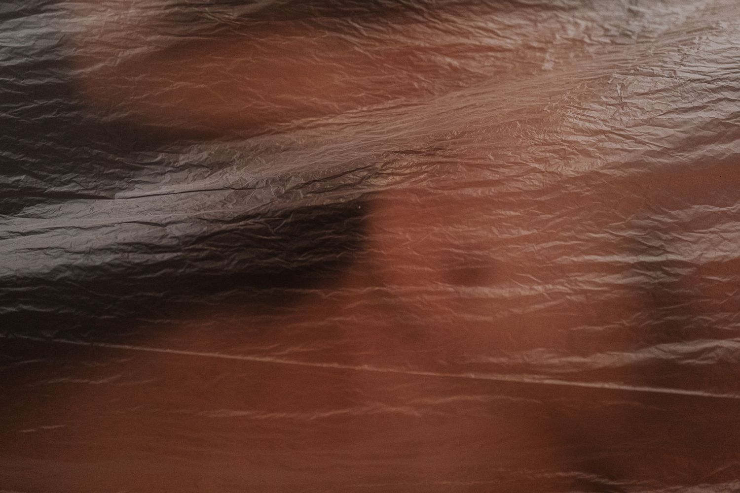 Abstract textured background with dark and reddish brown tones.