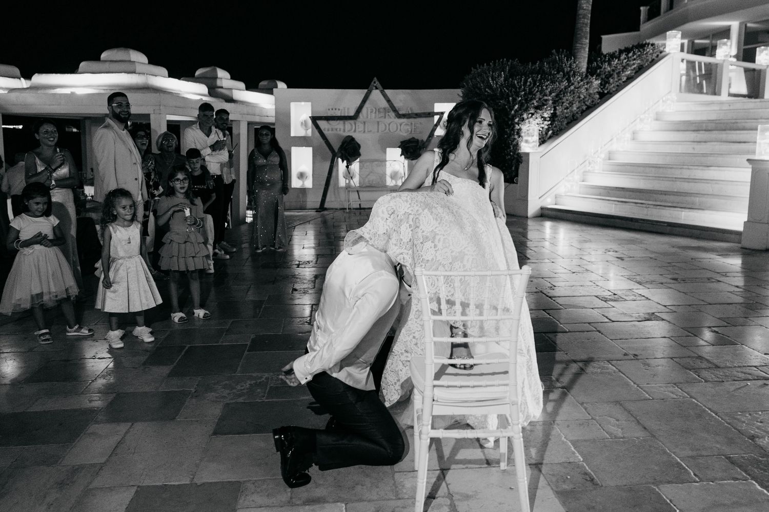 Black and white photo of a wedding reception dance party.