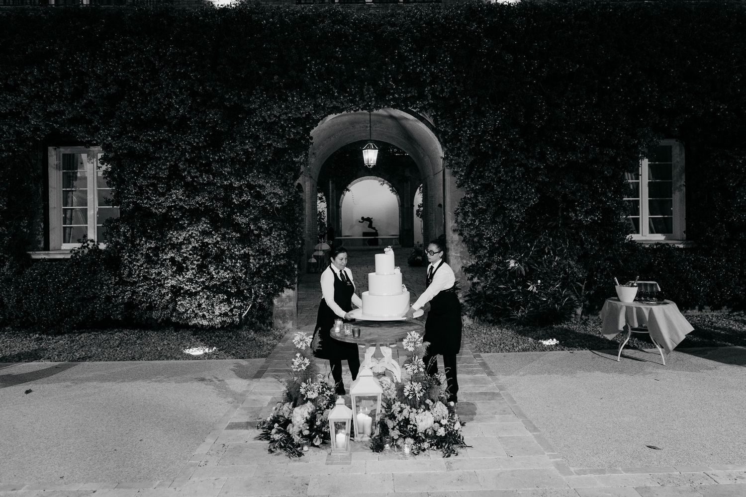 Nighttime panoramic view of venue exterior with guests.