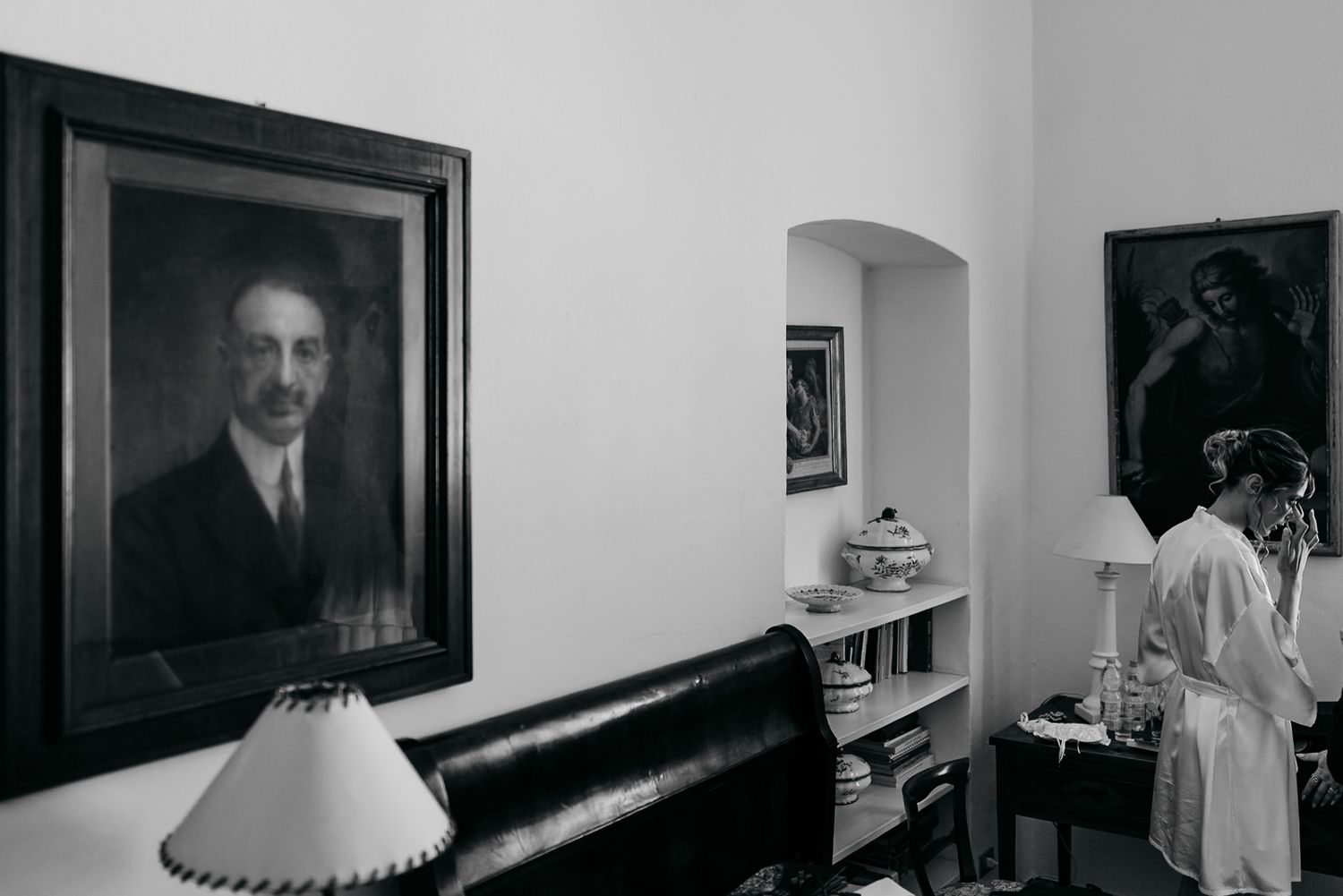 A series of black and white photographs arranged in a horizontal row on a wall.