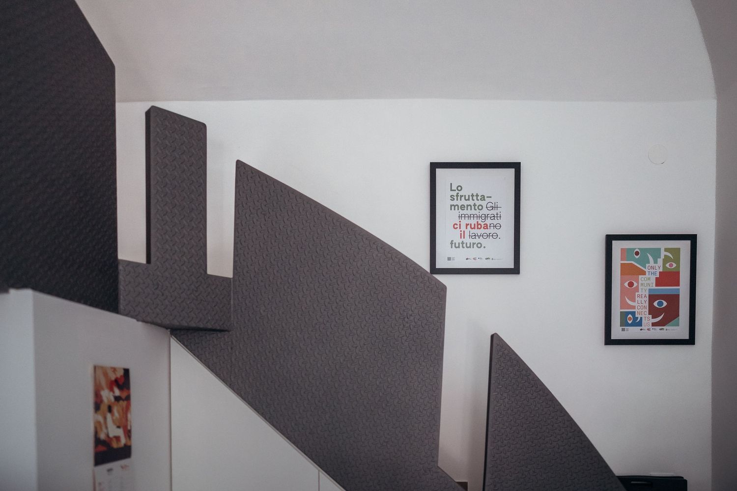 Interior wall with geometric grey shapes and framed artwork.