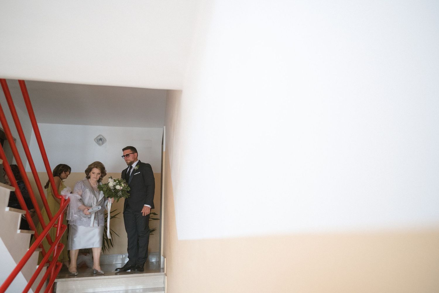 A series of four similar photographs arranged horizontally showing a white interior space with a red ladder visible.