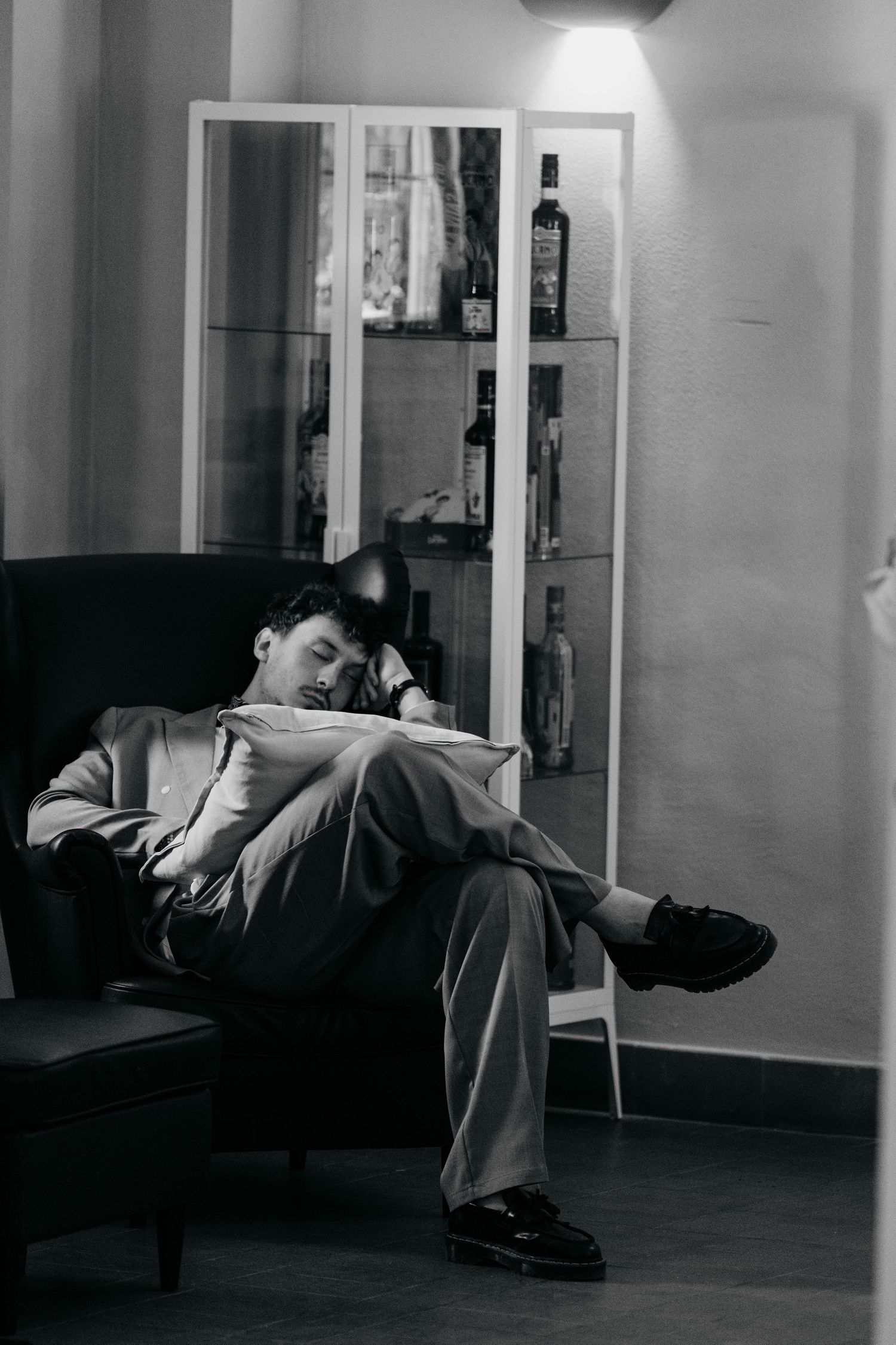 Black and white series of relaxed moments on a couch in an interior setting.