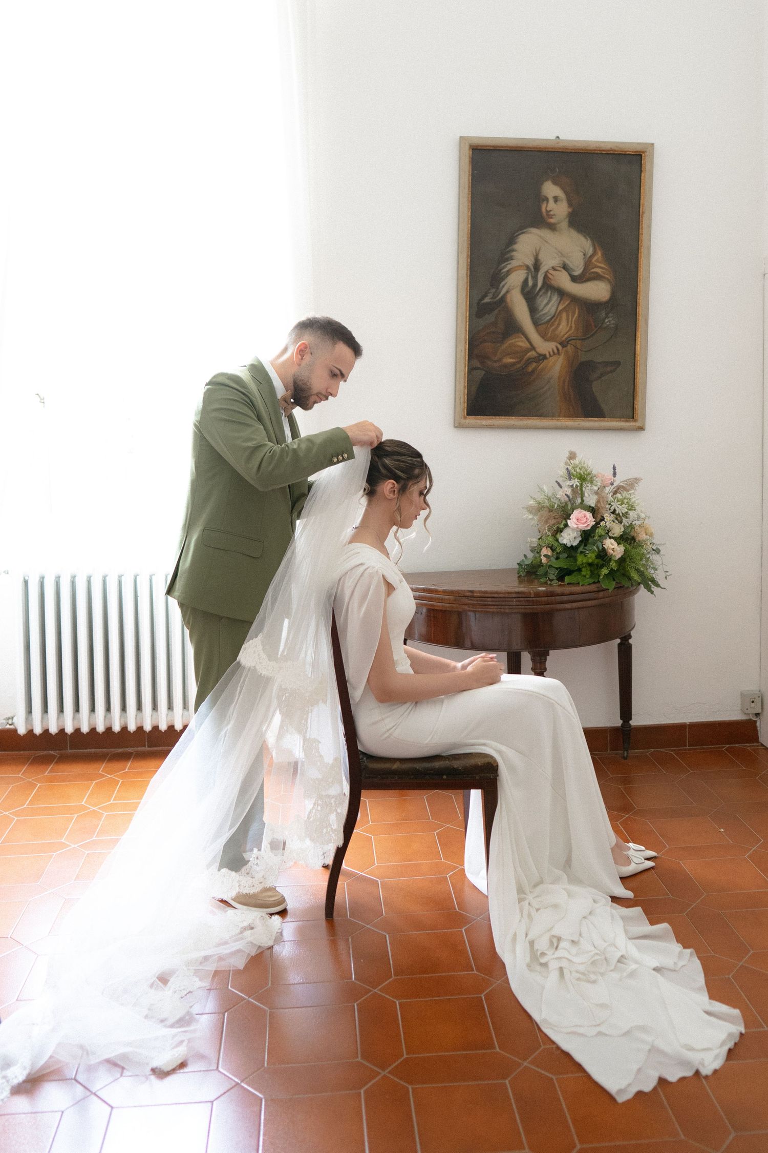 A series of artistic wedding preparation photos showing a flowing white dress against terracotta flooring.