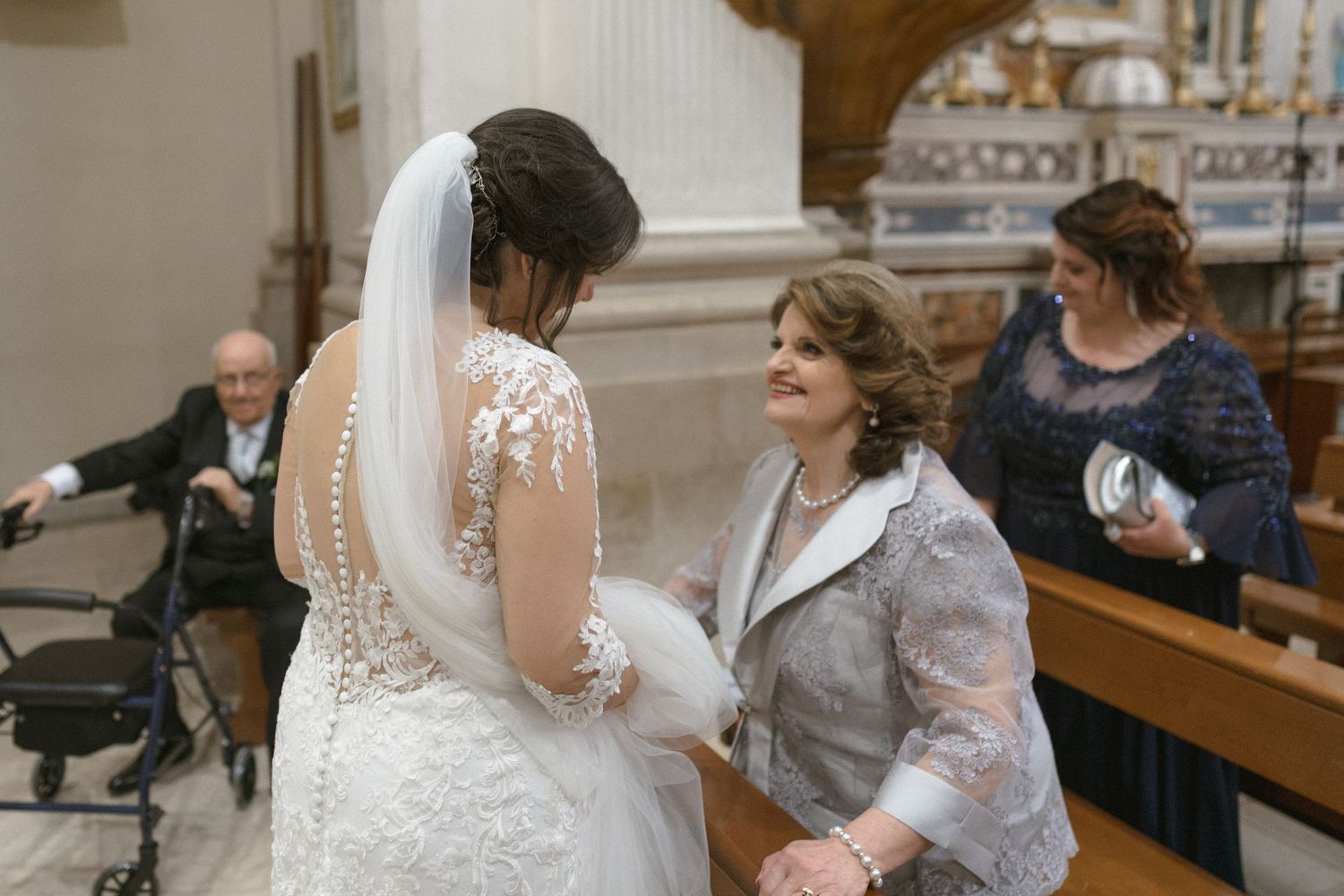 Wedding celebration inside traditional church with wooden pews.