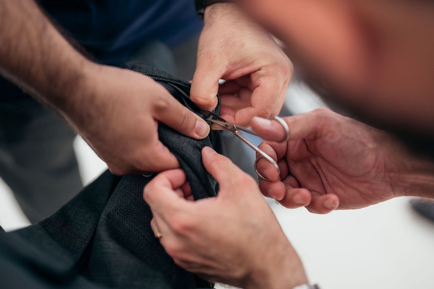 Close-up of hands adjusting formal attire details.