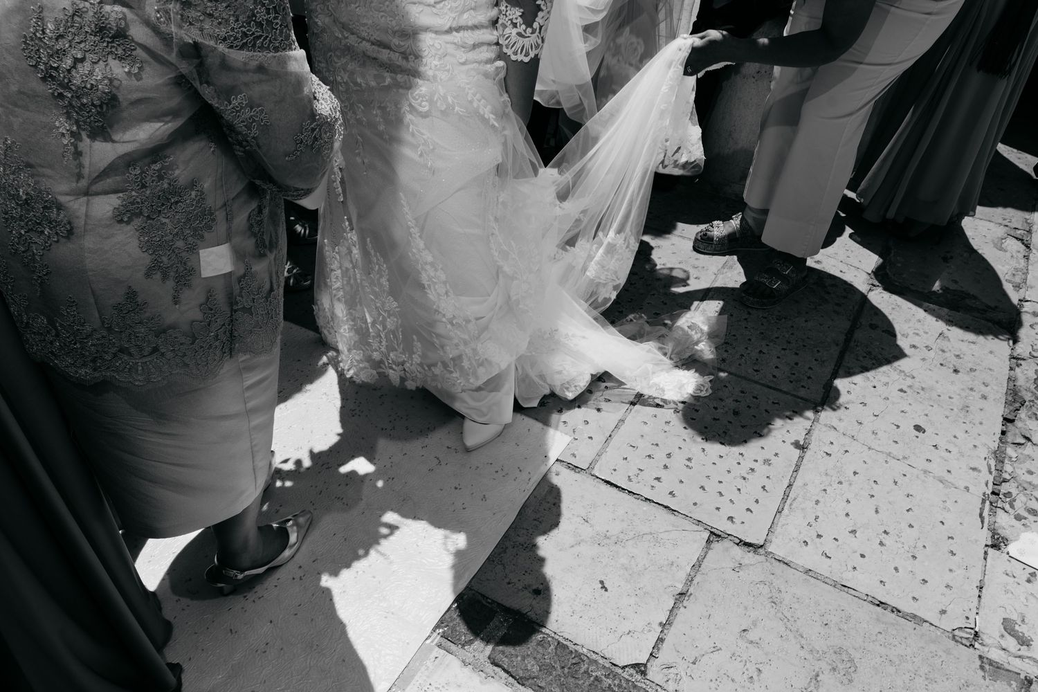 Black and white photo showing guests mingling at an elegant wedding reception.