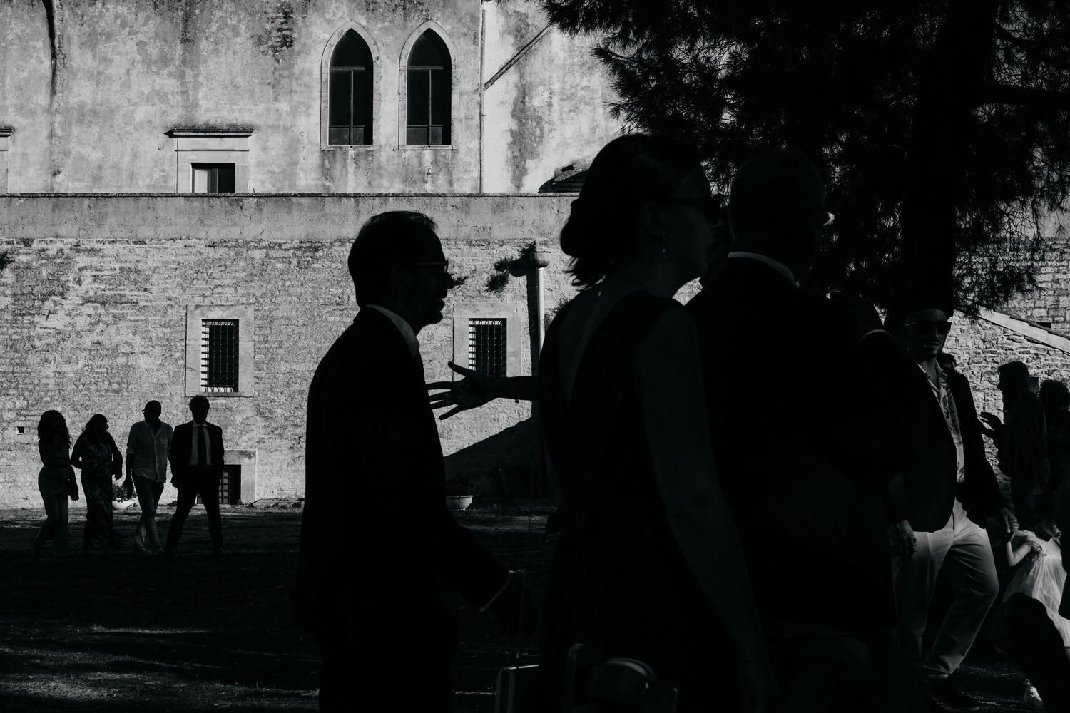 A silhouetted scene against a gothic church backdrop at a wedding.