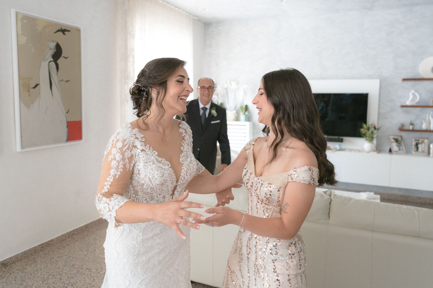 Wedding party celebrating in bright white modern indoor venue.