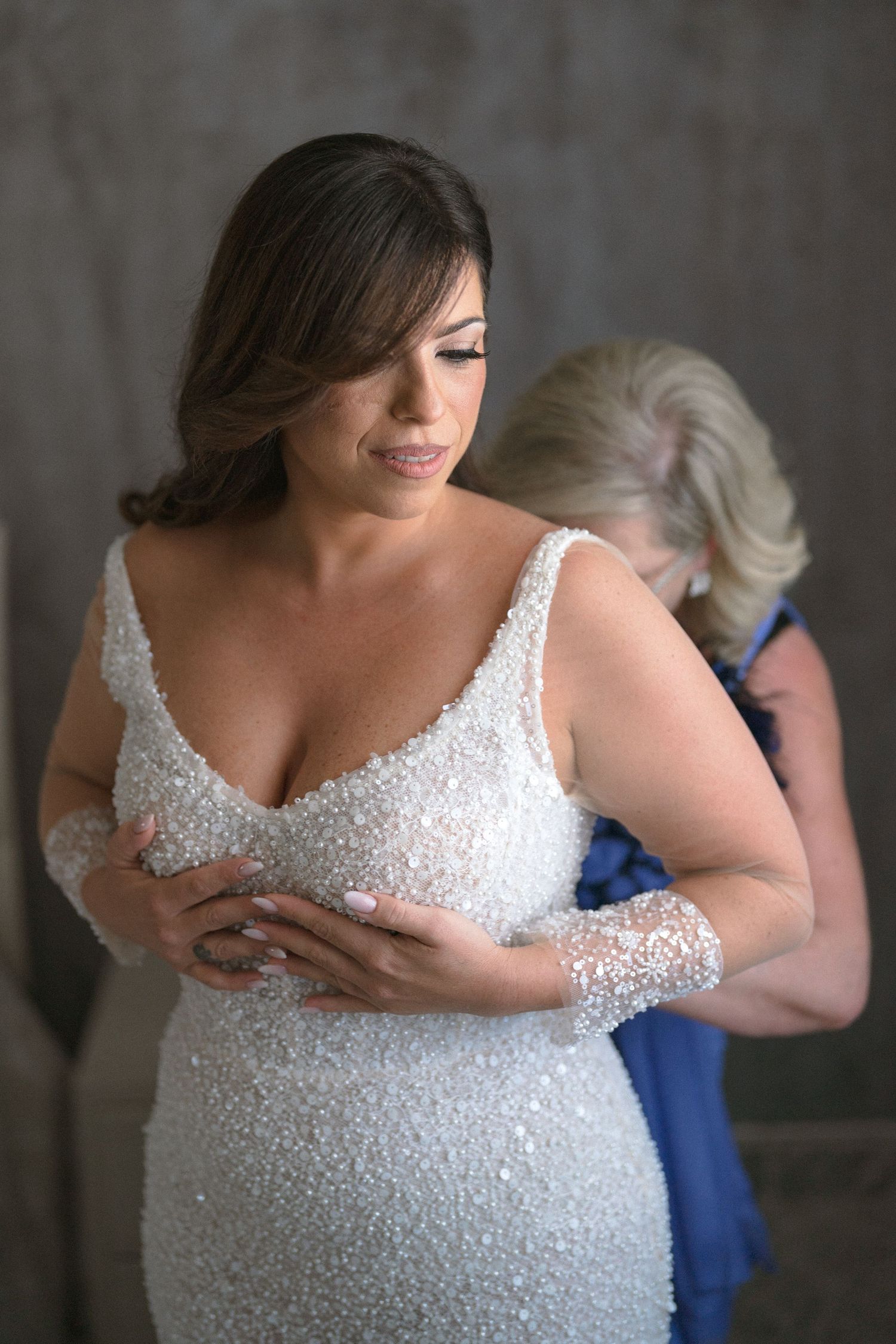 Close-up sequence showing details of a sparkly white wedding dress bodice.