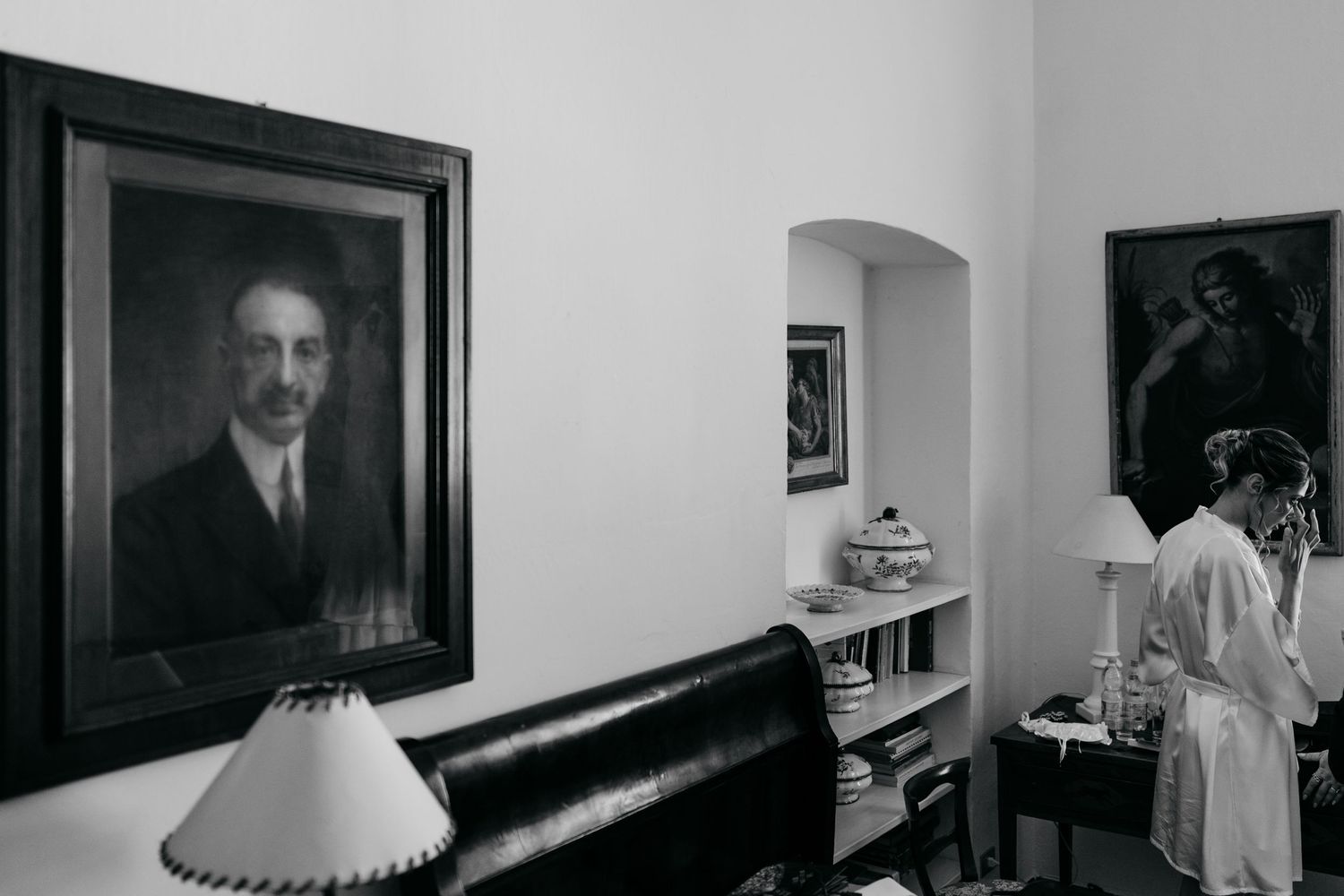 Black and white photographs line the walls of an interior hallway or gallery space.