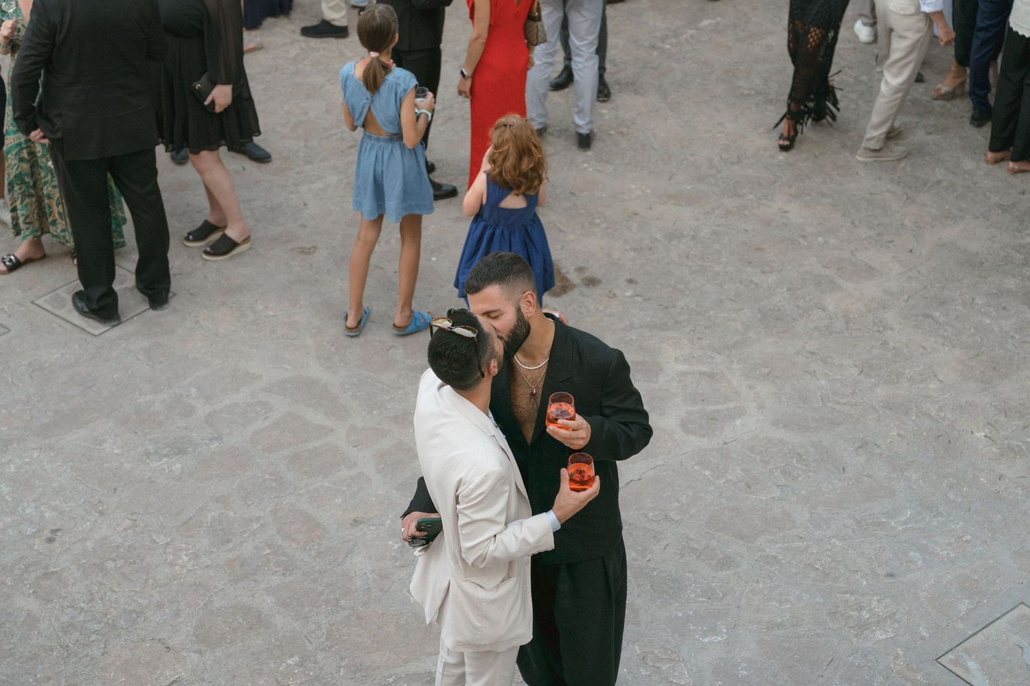 Wedding guests mingling and socializing during an outdoor cocktail hour.