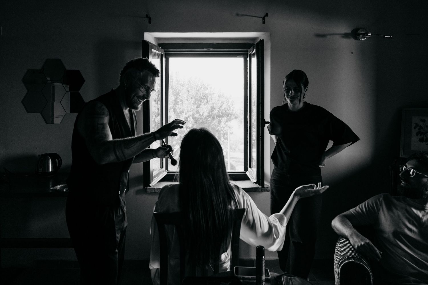 A series of black and white photographs showing silhouettes of people in doorways and windows.