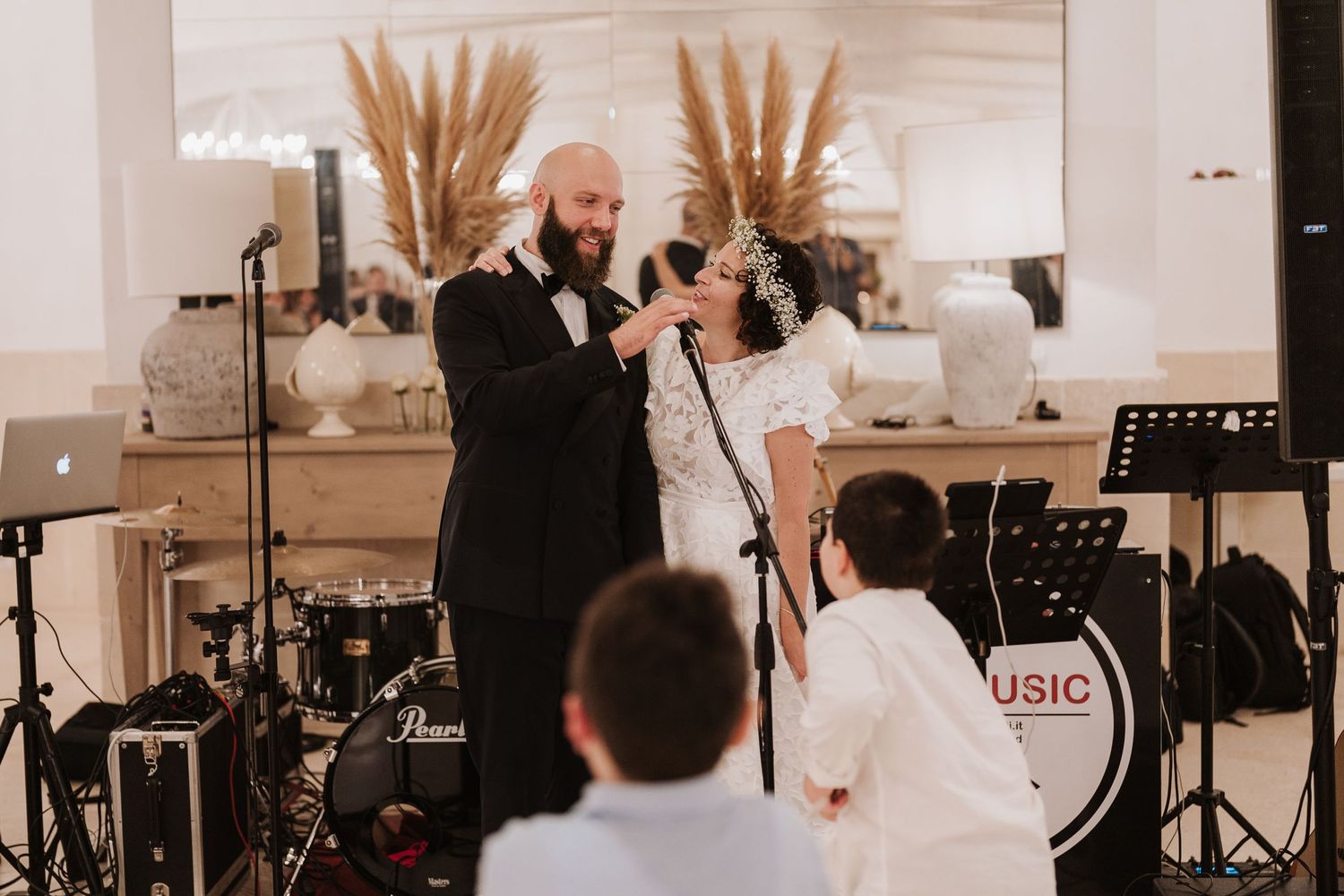 Wedding celebration scene with live music performance at decorated indoor venue.