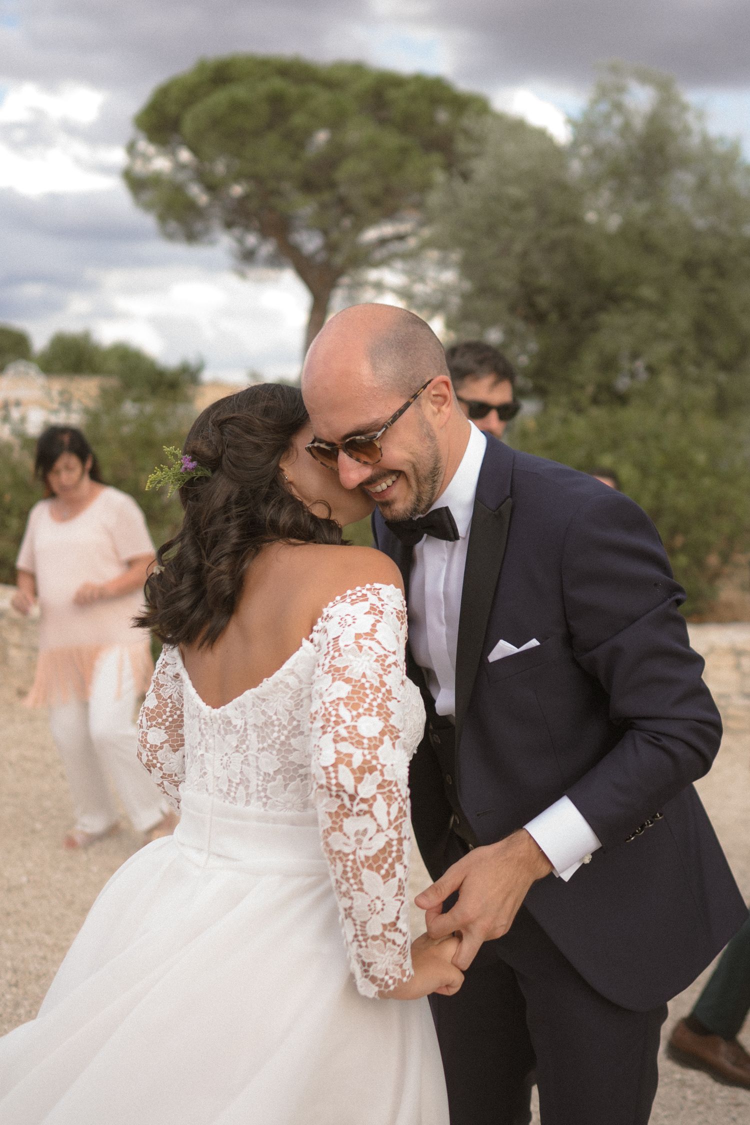 Romantic outdoor wedding portraits with a lace dress against a natural backdrop.