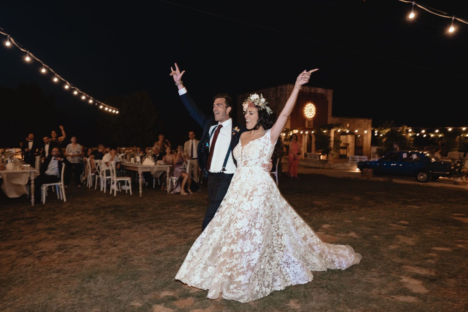 Wedding reception at night with string lights and dancing under the stars.