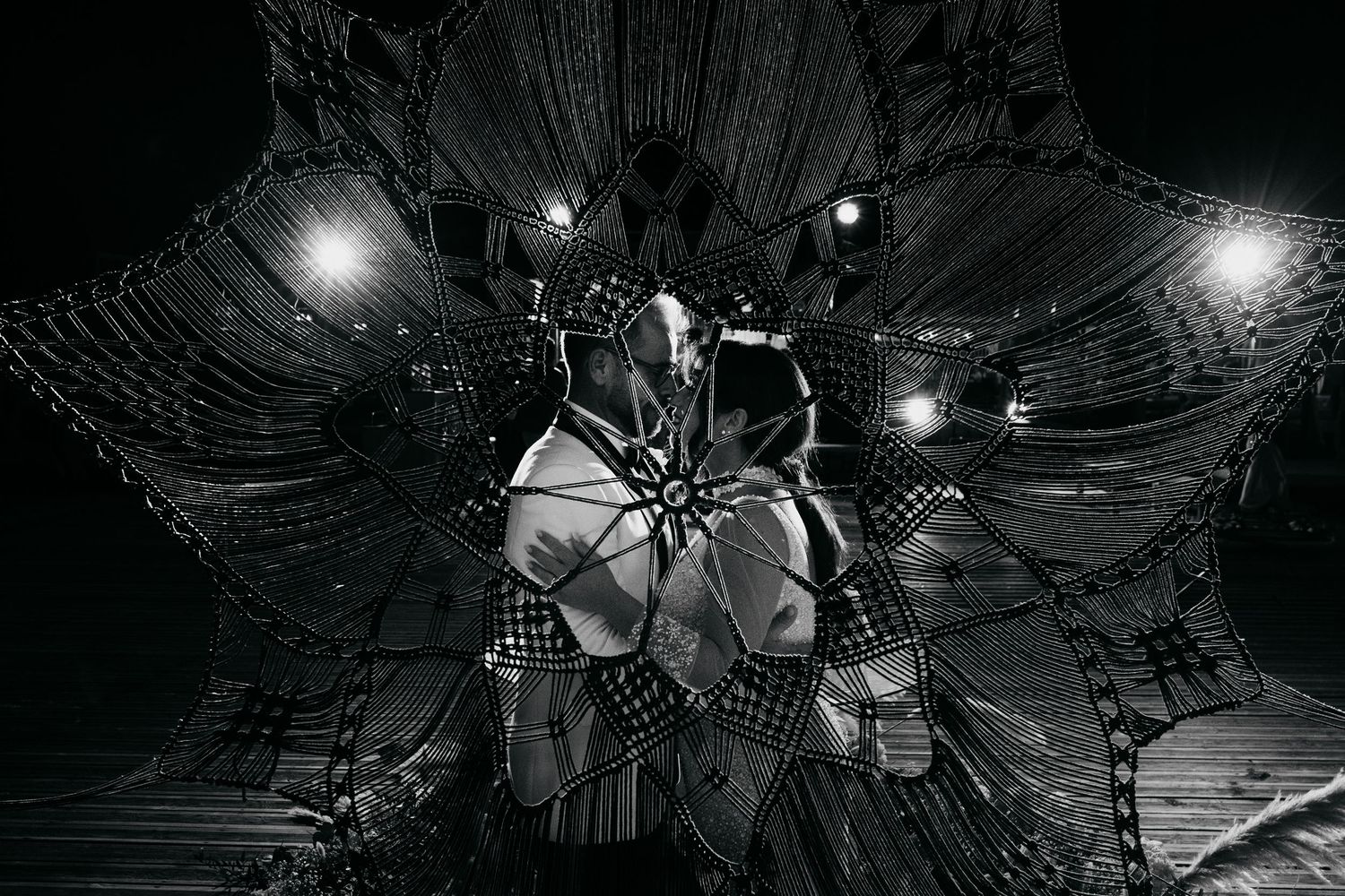 Dramatic black and white ceiling detail with chandelier and architectural patterns.