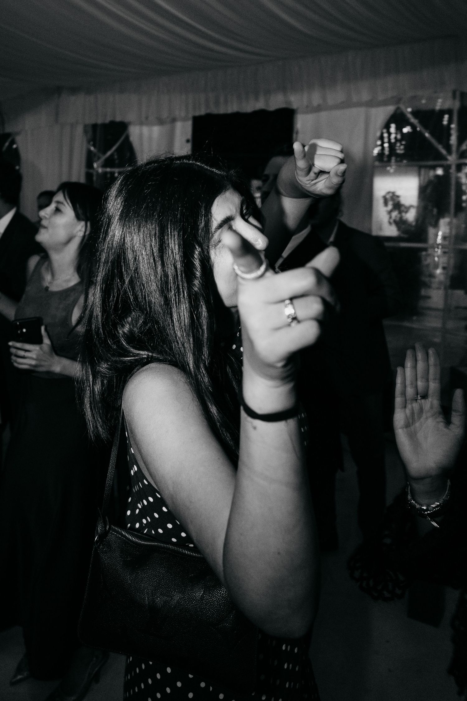 Black and white photos of party guests dancing and celebrating at a nighttime event.