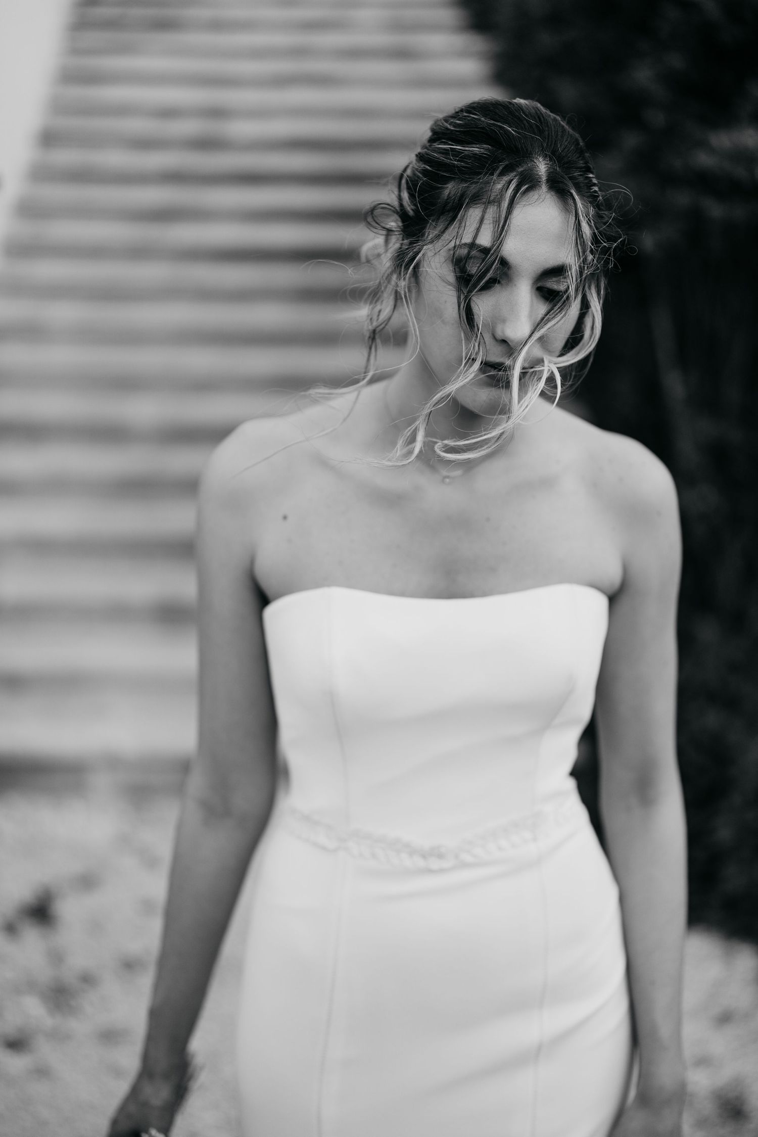 Close-up details of an elegant strapless white wedding gown.