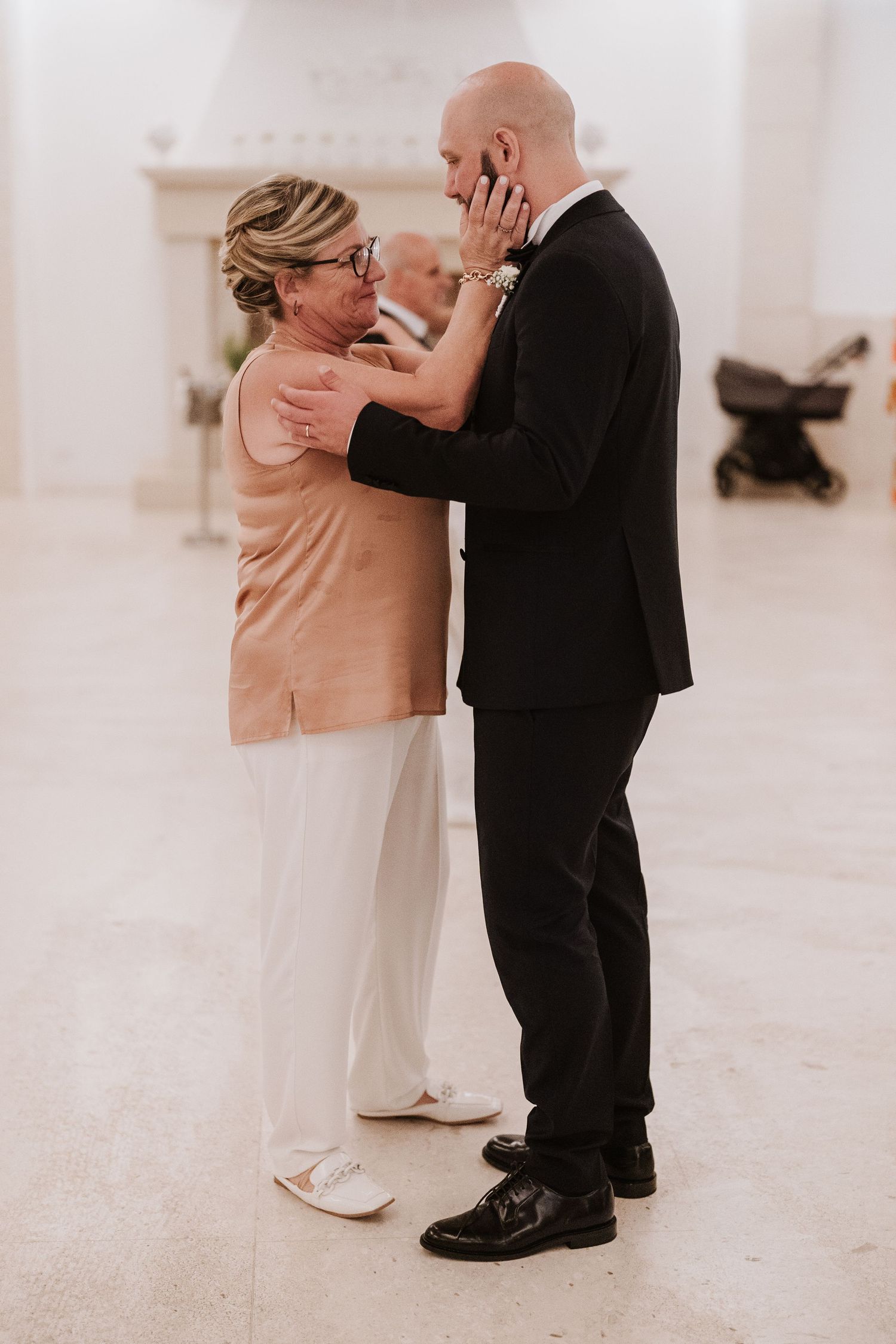 An emotional moment shared between two people during a wedding celebration.