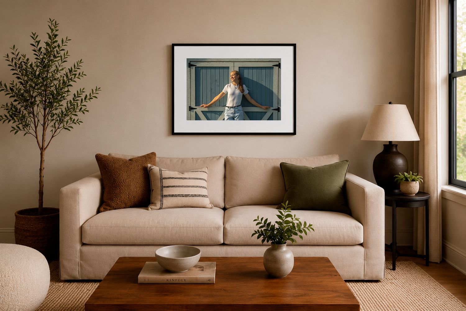 Cozy beige living room with linen sofa, wood coffee table, green plants, and framed artwork above.
