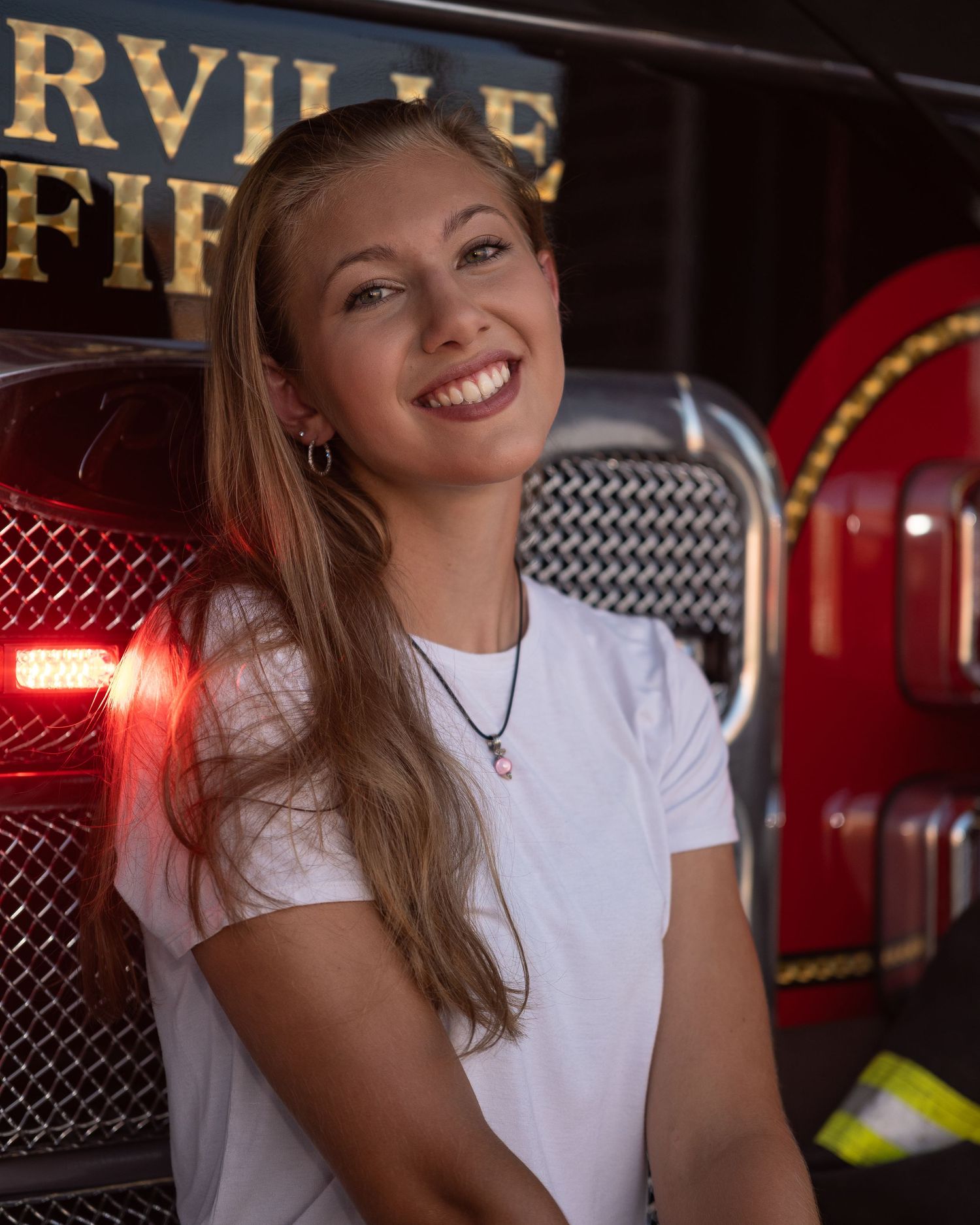 Portrait in vintage diner setting with red neon lights.