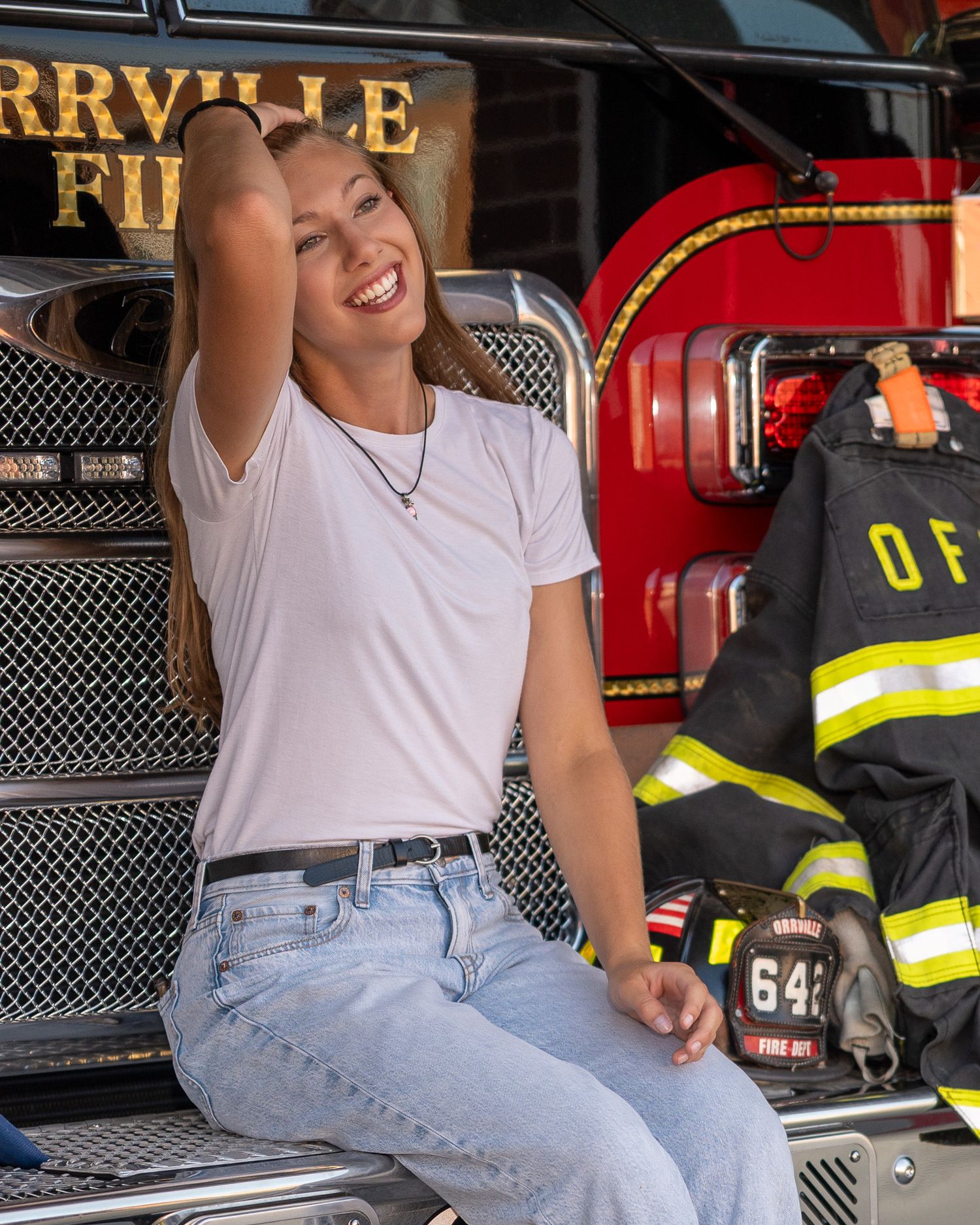 Casual outfit against fire truck with Orrville Fire Department signage visible.