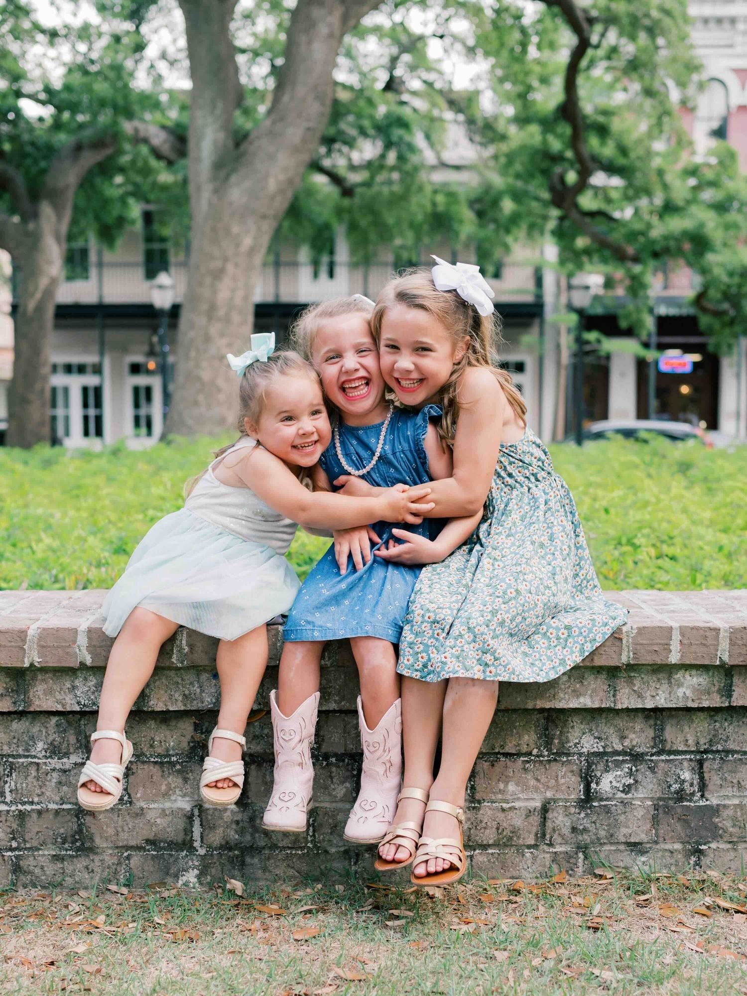 Three sisters laughing beneath live oak trees in downtown Mobile, Alabama family photos