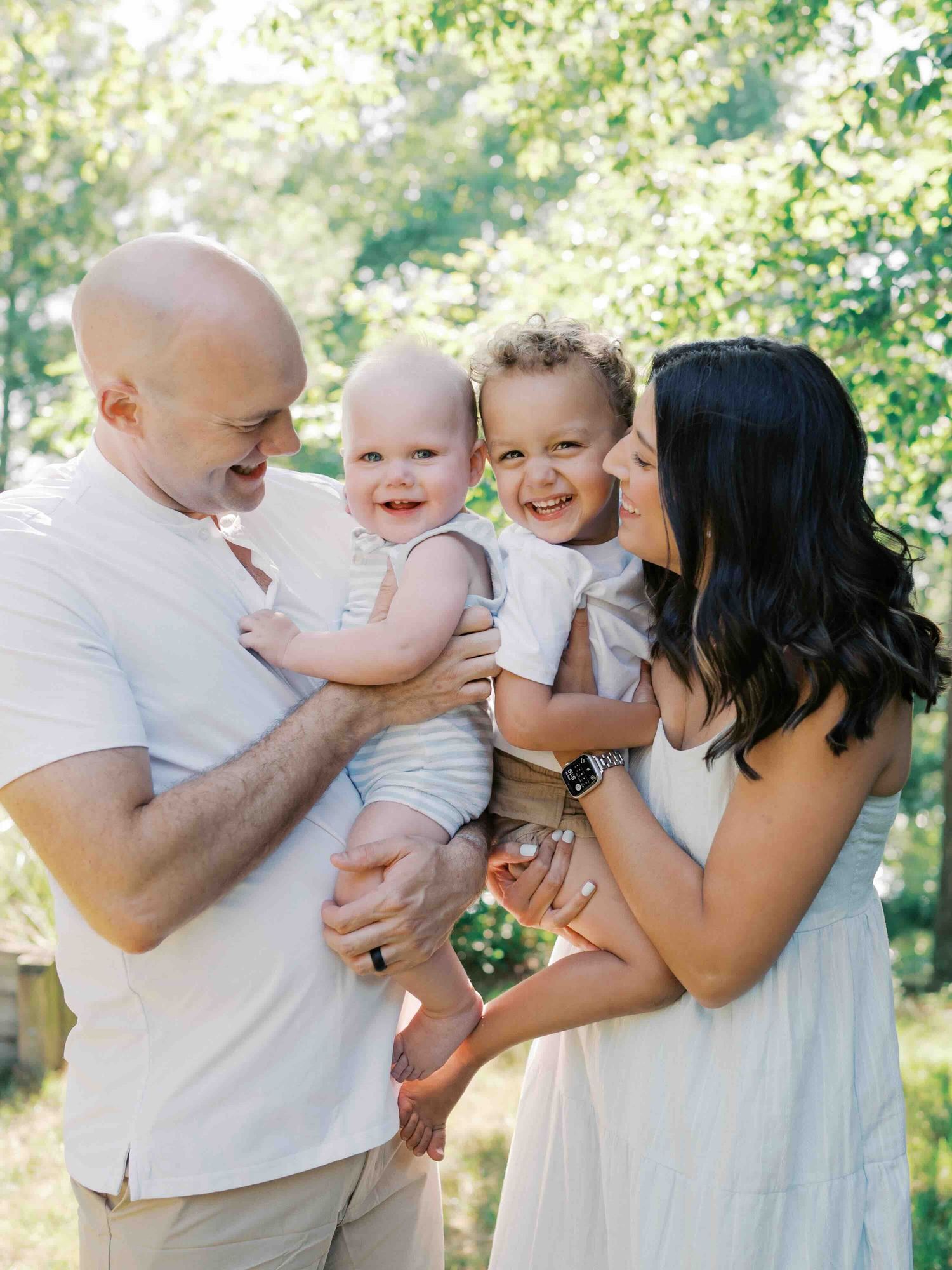 Family laughing together during an outdoor session in Mobile, Alabama.