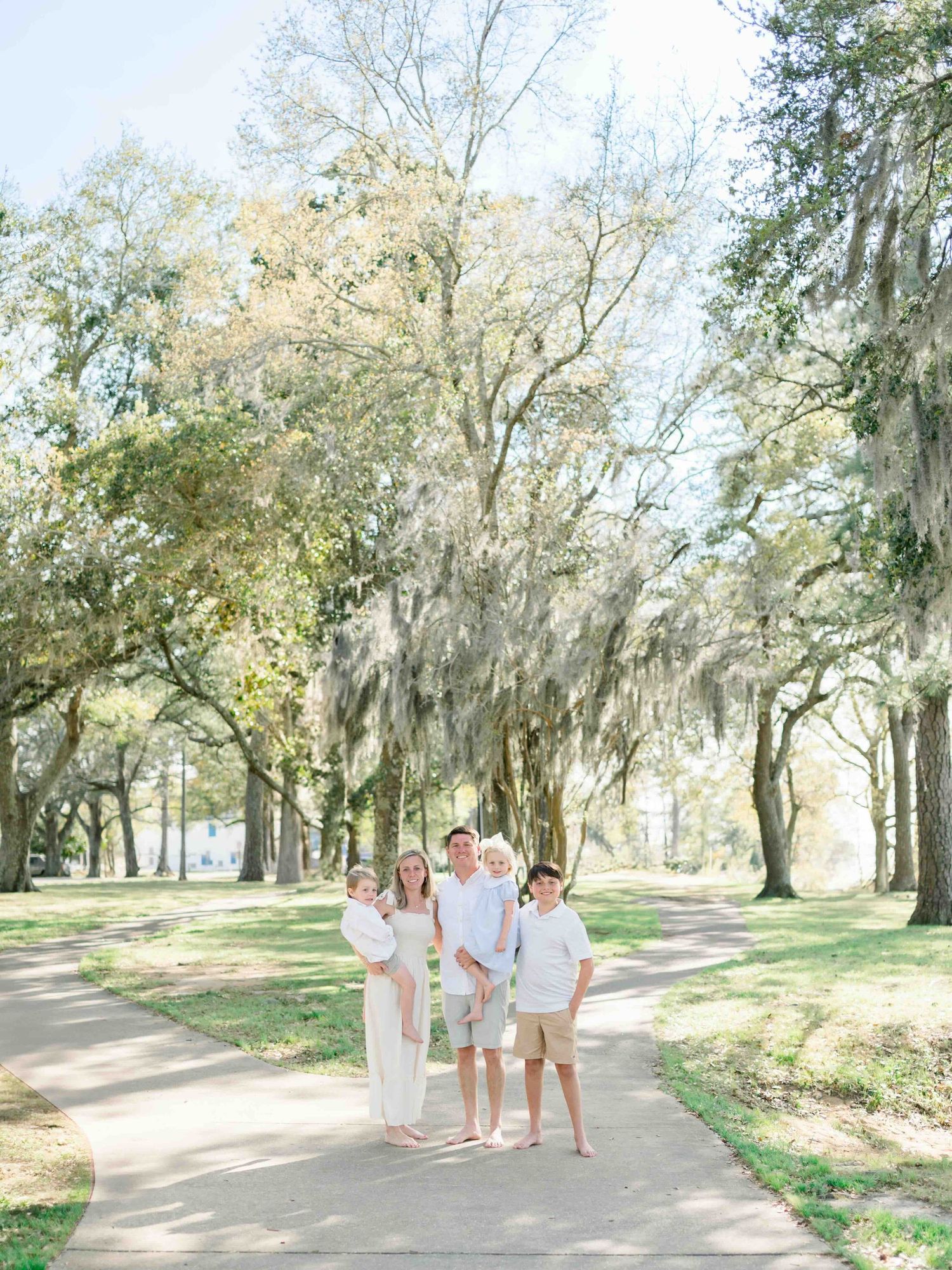Gulf Coast  family photography session in Fairhope with candid moments under the mossy oaks