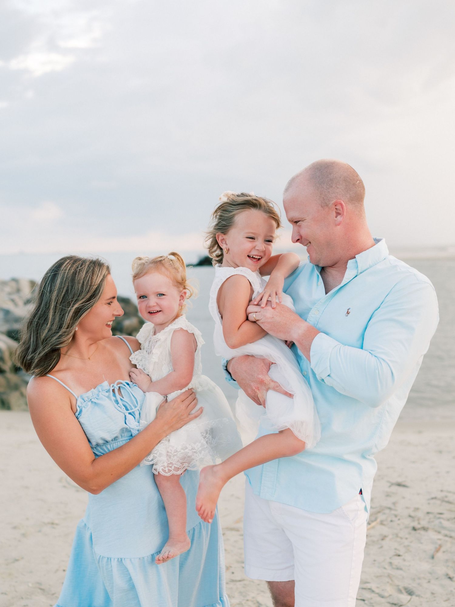 Parents and children playing together during family photography session in Dauphin Island
