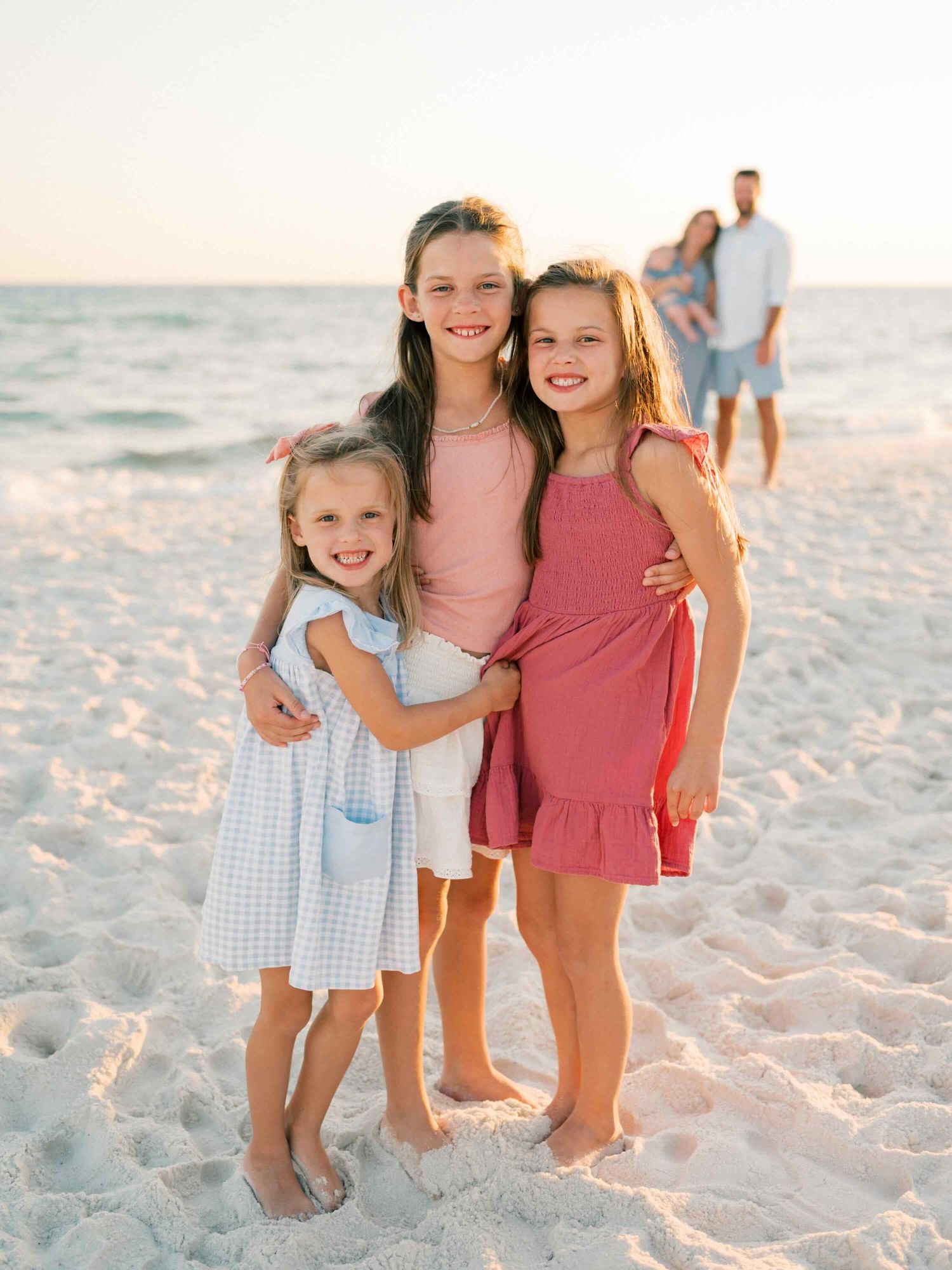 Sisters hugging during family photography session in Orange Beach Alabama