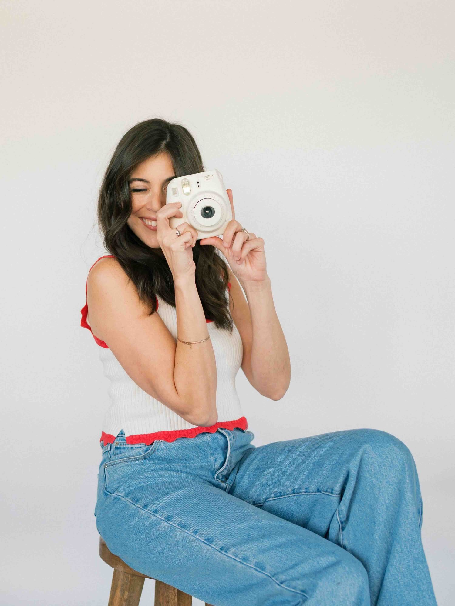 woman holding camera during natural light portrait session in mobile alabama
